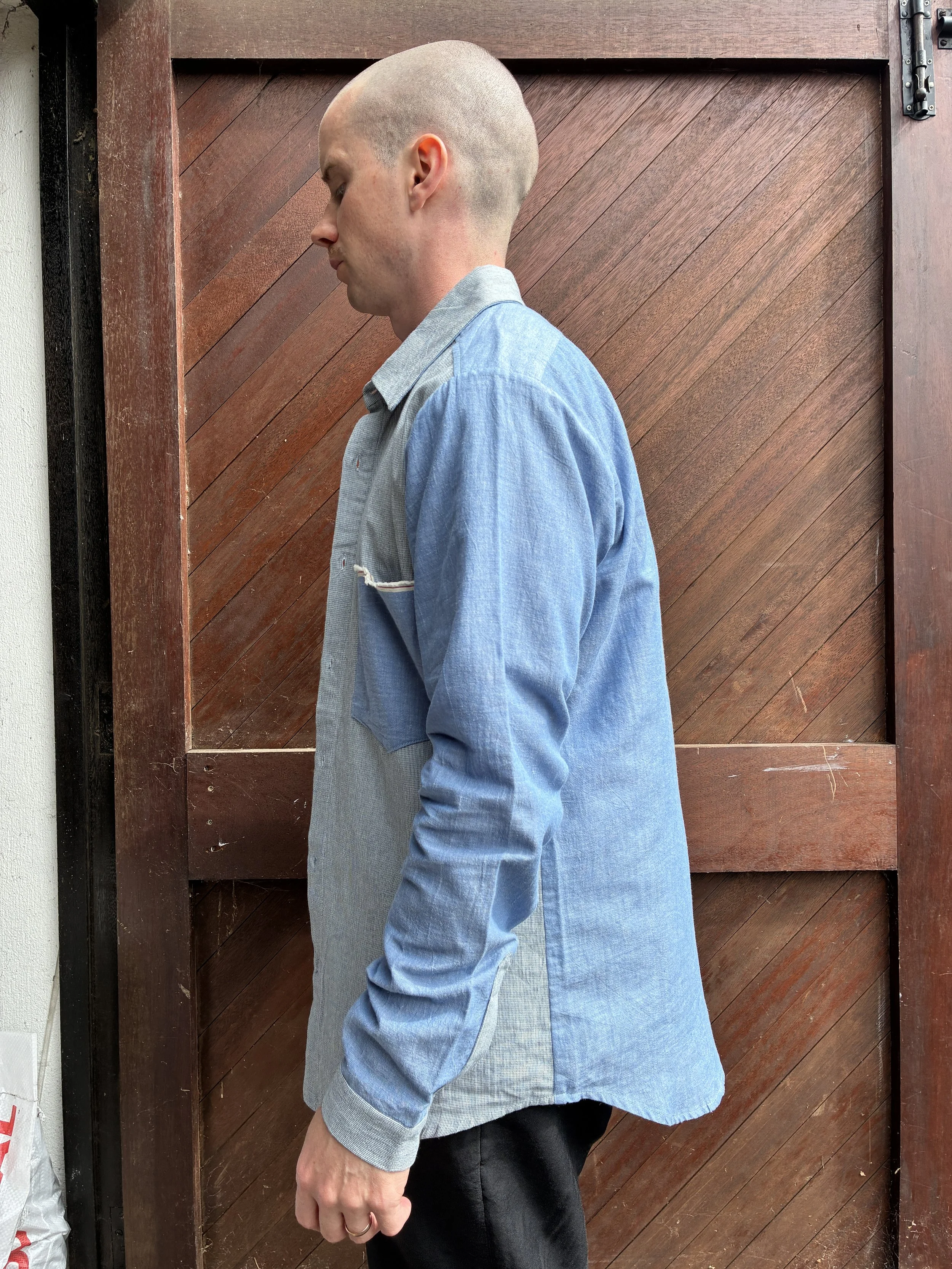 Side of man in front of door wearing Frank Leder Blue Patchwork Vintage Fabric Edition Shirt