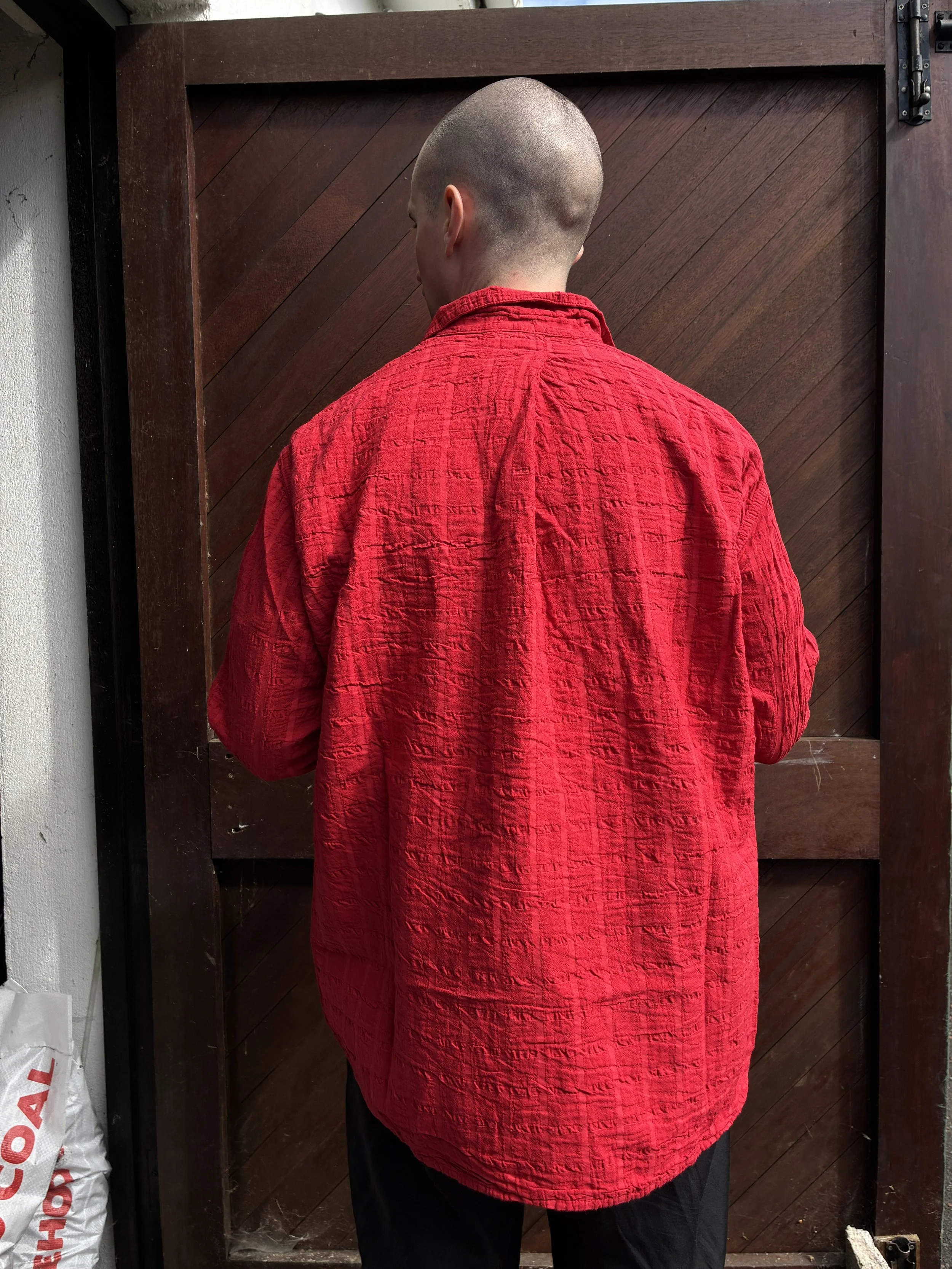 Back of Man in front of wooden door wearing Red Tender Co. 468 Flipped Collar Shirt