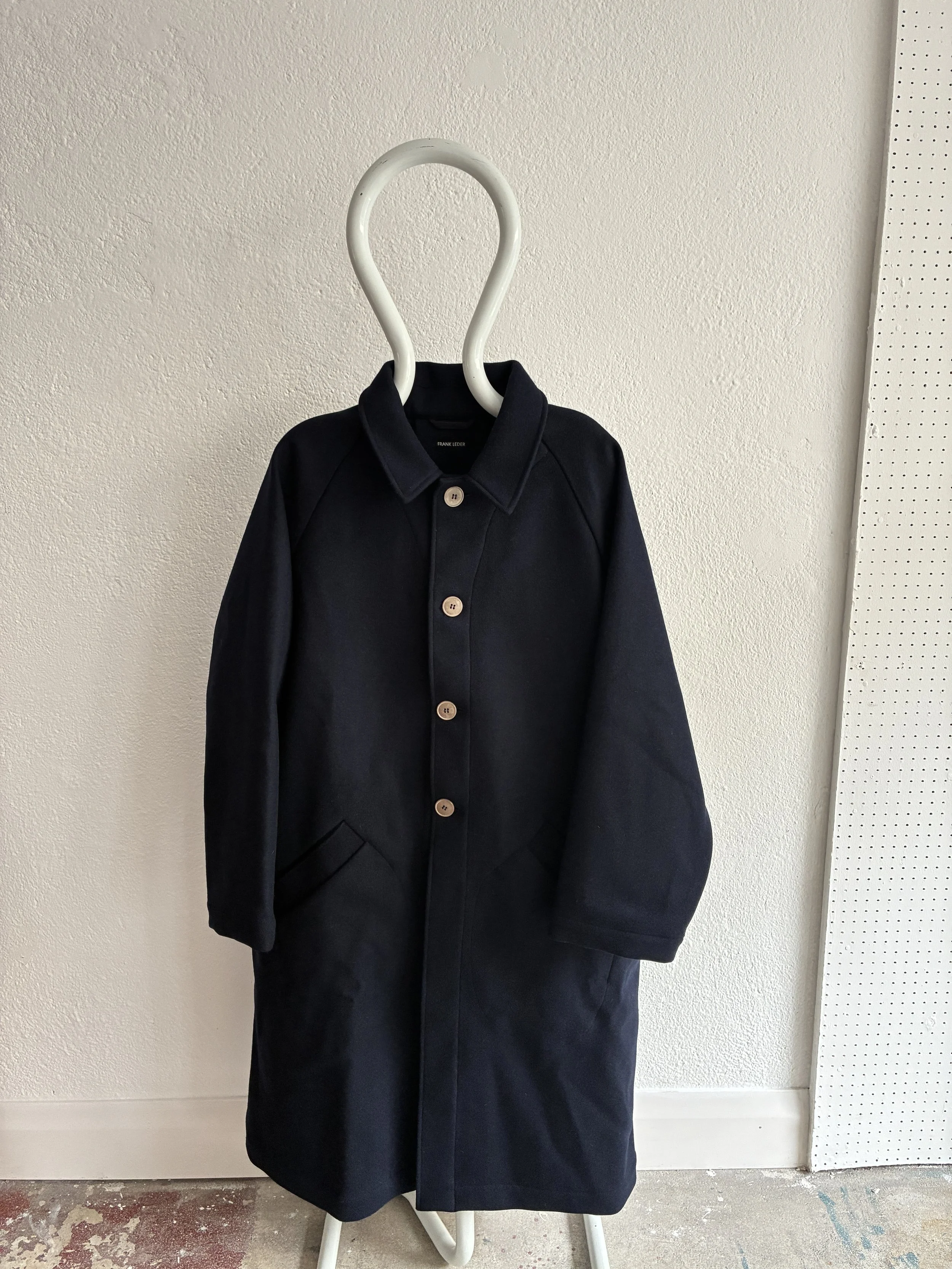 Mannequin wears Frank Leder Navy Wool Duster Coat, front profile view