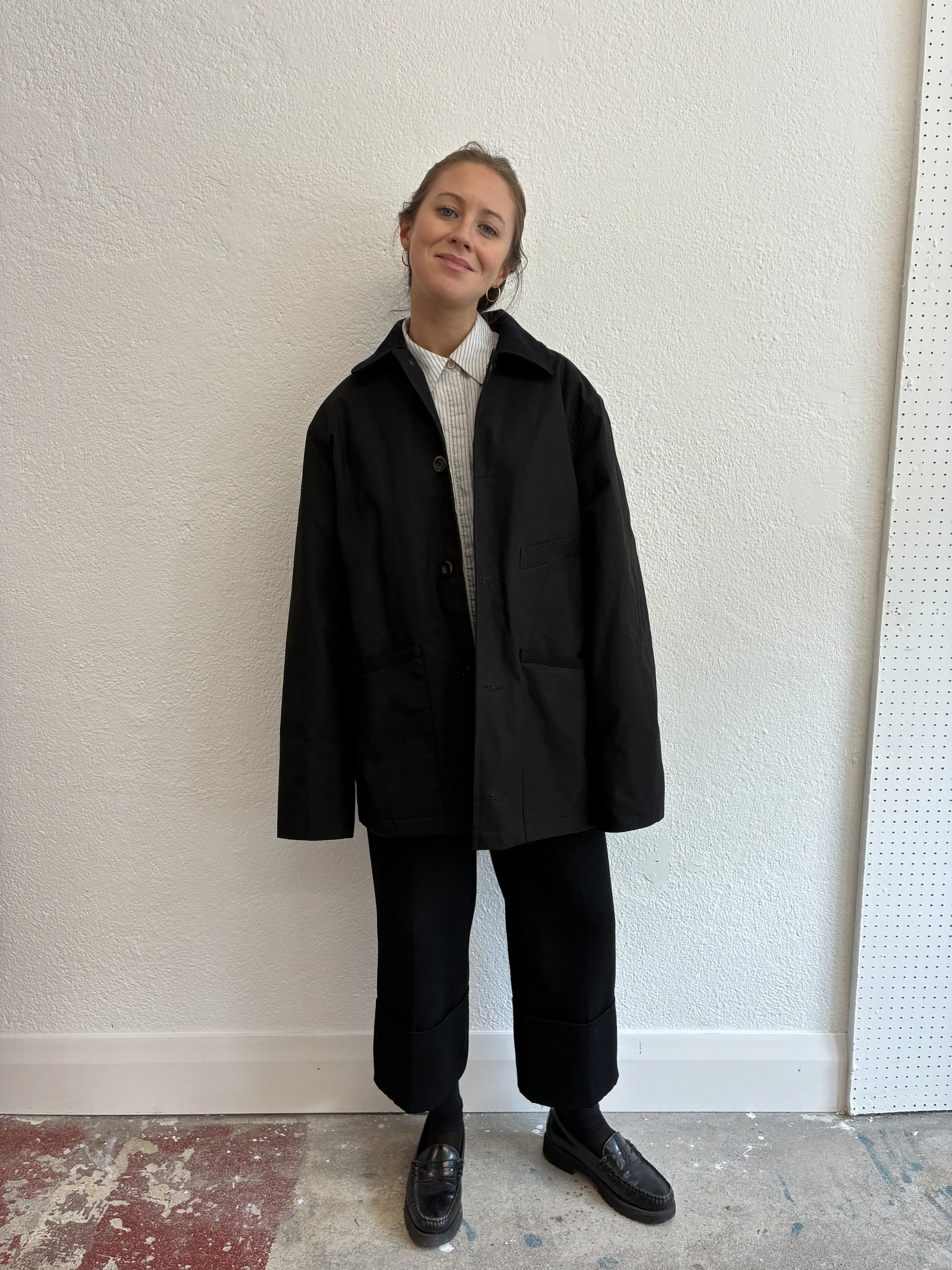 Woman wearing Black Conkers Blanket Jacket in front of white wall