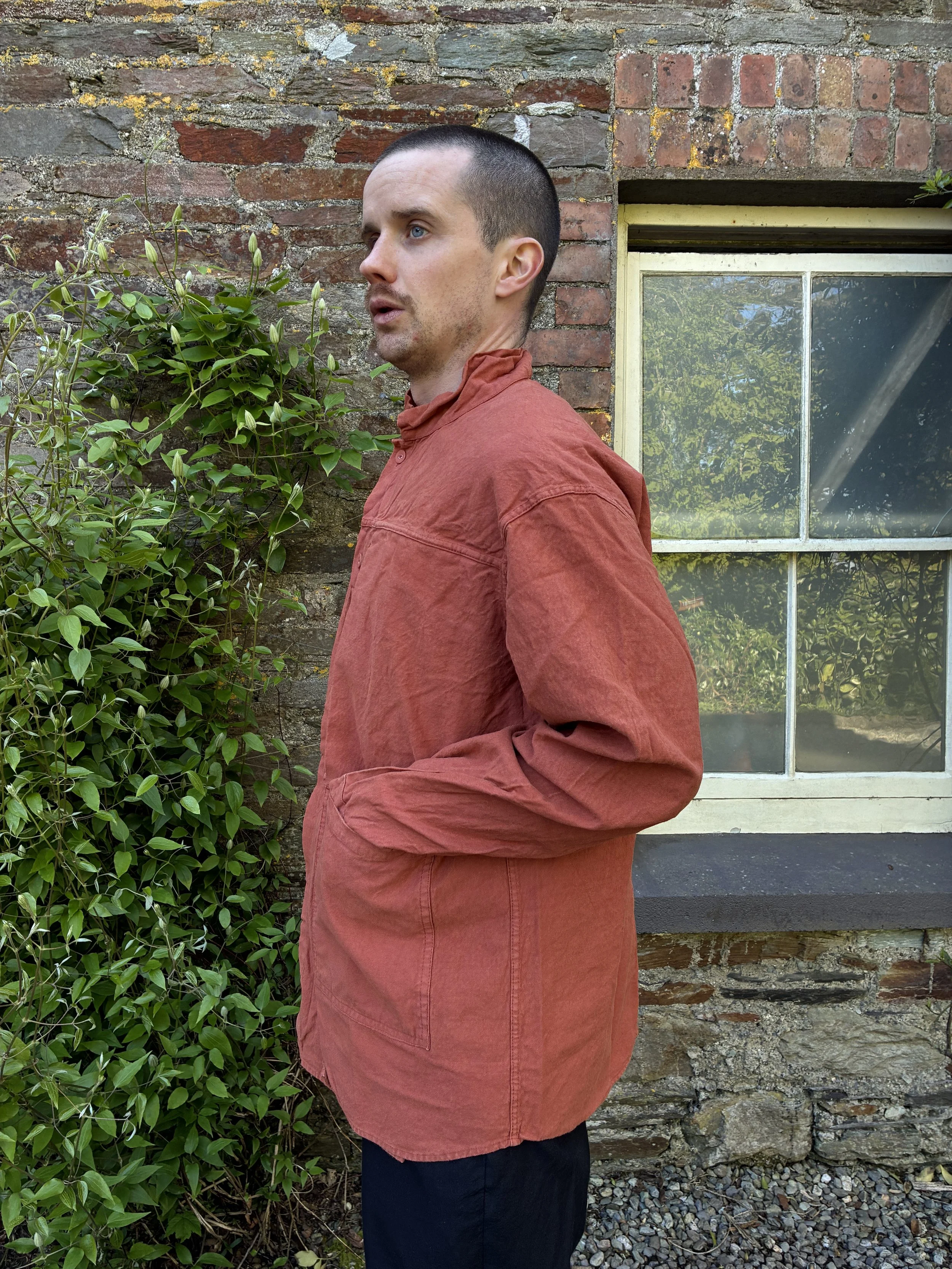 Side view of man wearing orange Tender Co 402 Two Birds Shirt