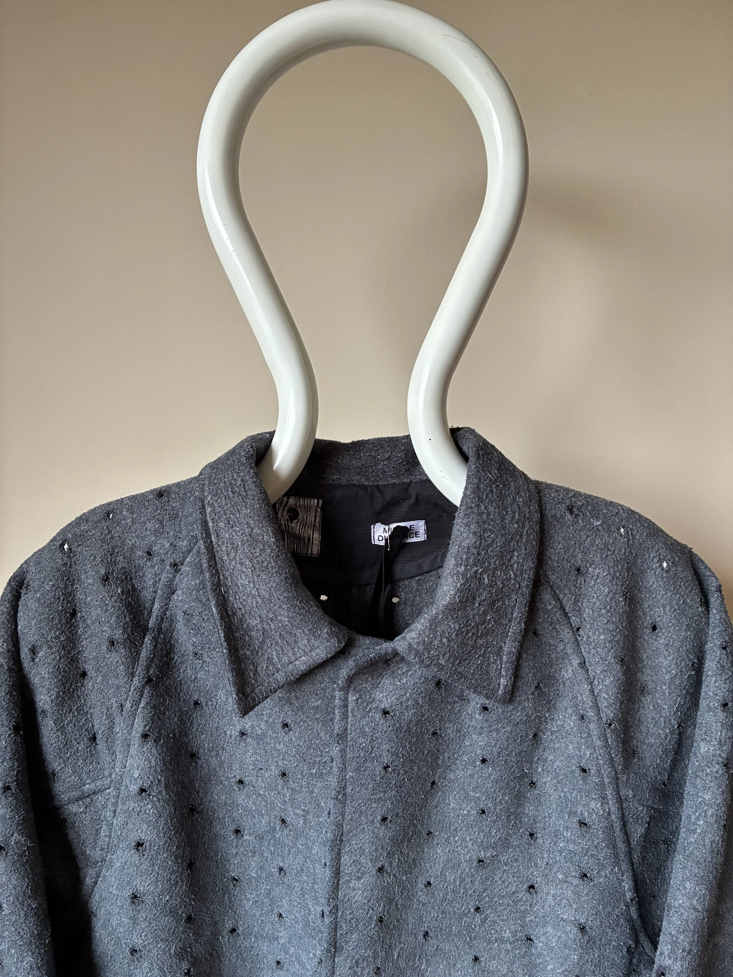 Close up of collar of Middle Distance grey Drill jacket on mannequin