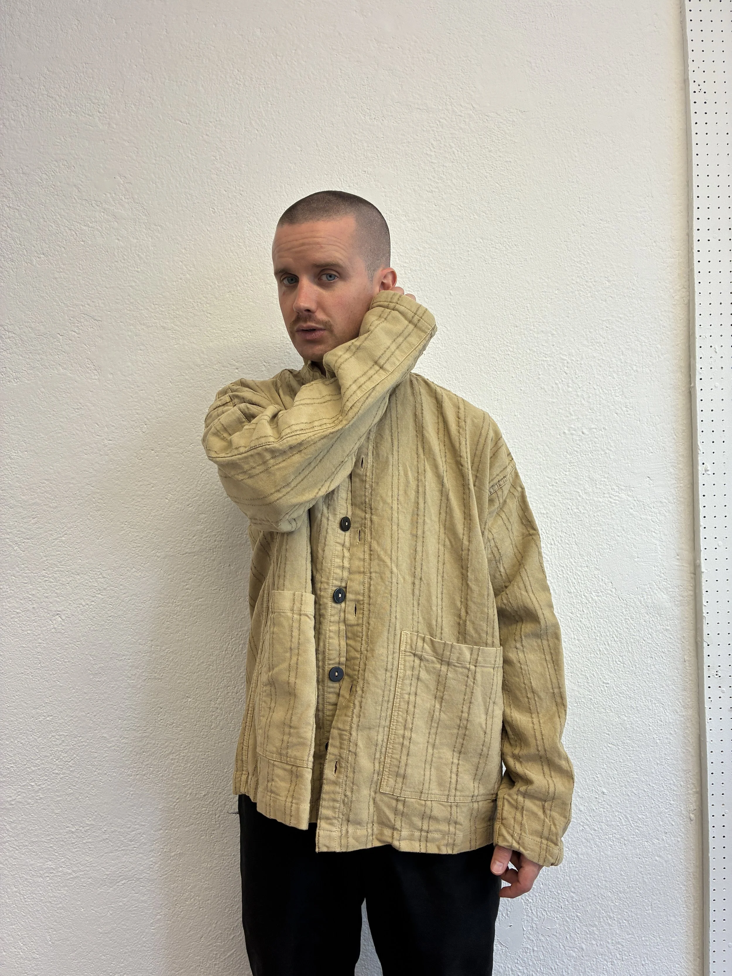 Man wearing  Drab Weld Tender Co Type 485 Isosceles Shirt in front of white wall