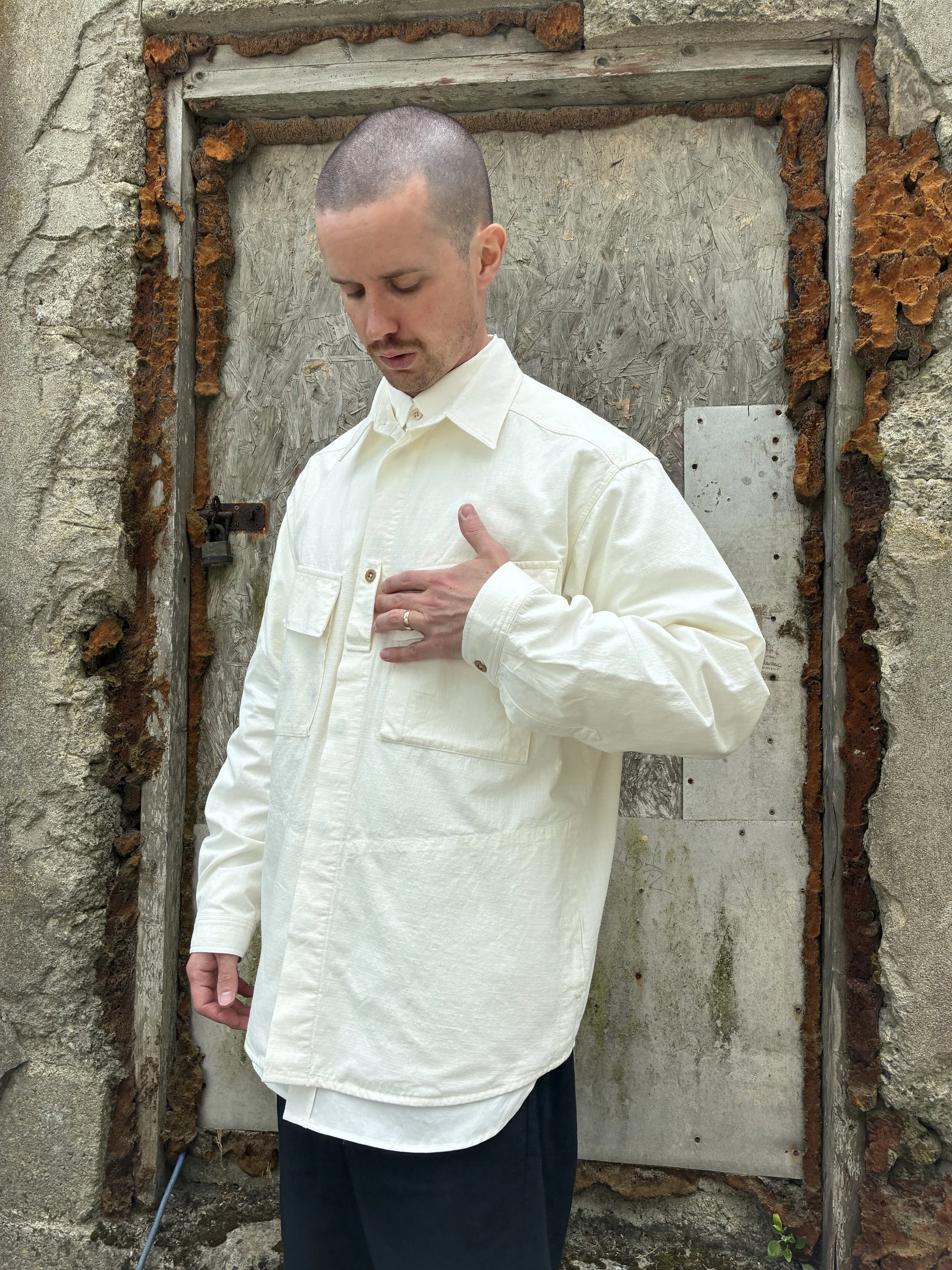 Man in front of wall wearing Off-White Ecru 1st PAT-RN Sumatra Overshirt