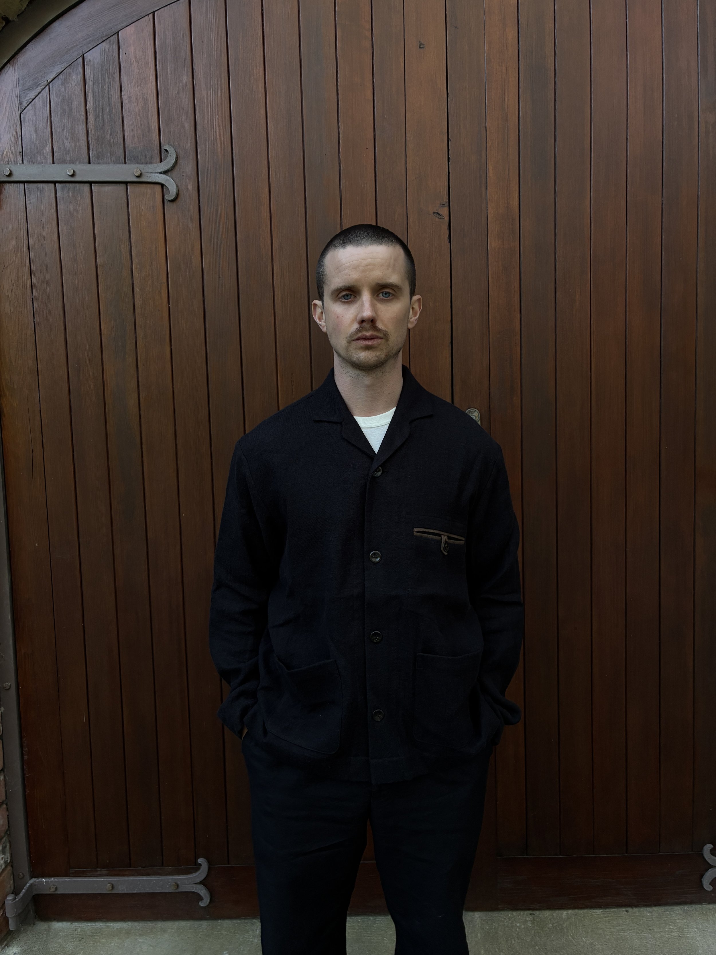 Man in front of door wearing Frank Leder Black Wool Shirt Jacket