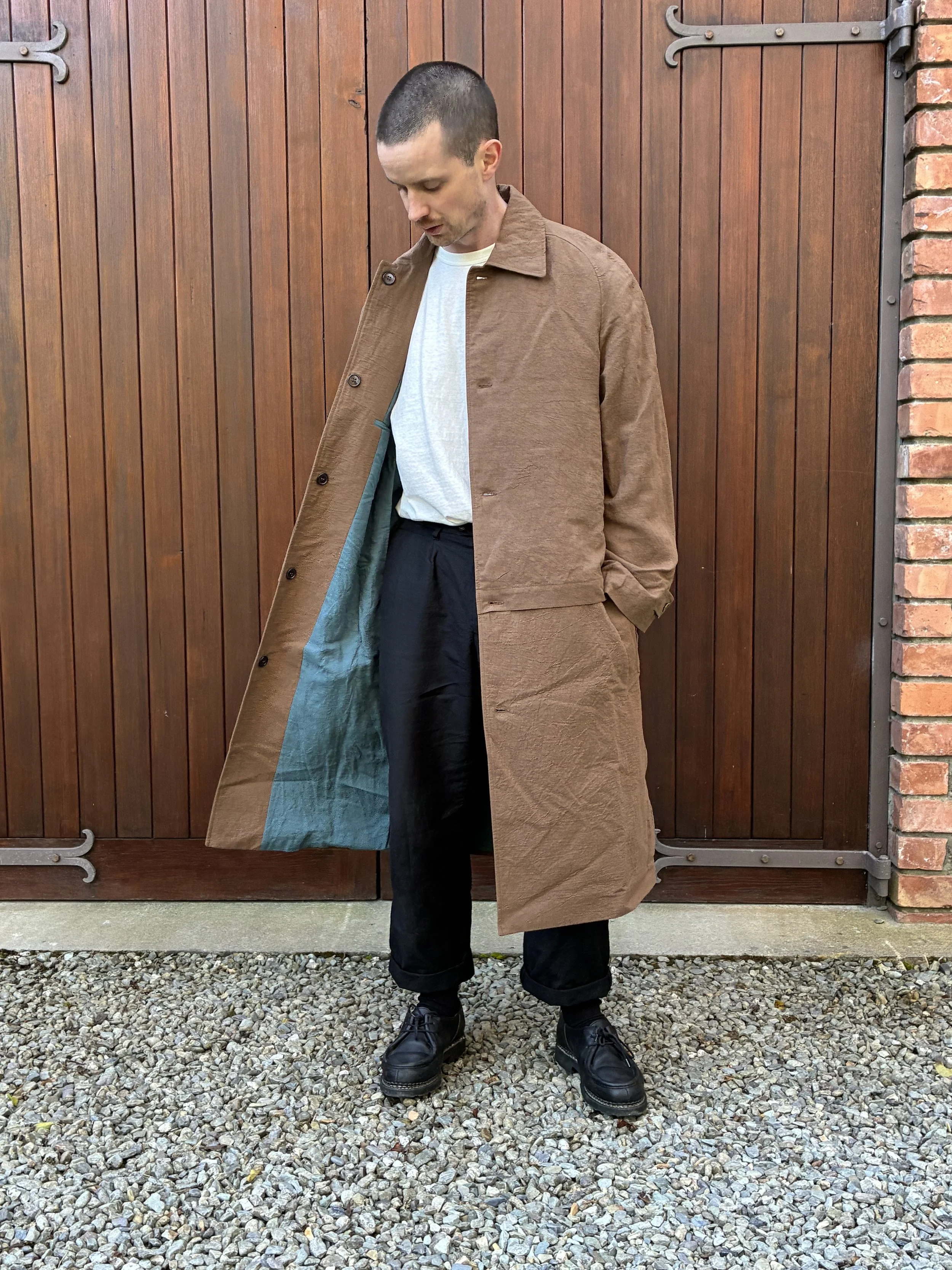 Wind blowing the bottom of Frank Leder Reversible Coat worn on man