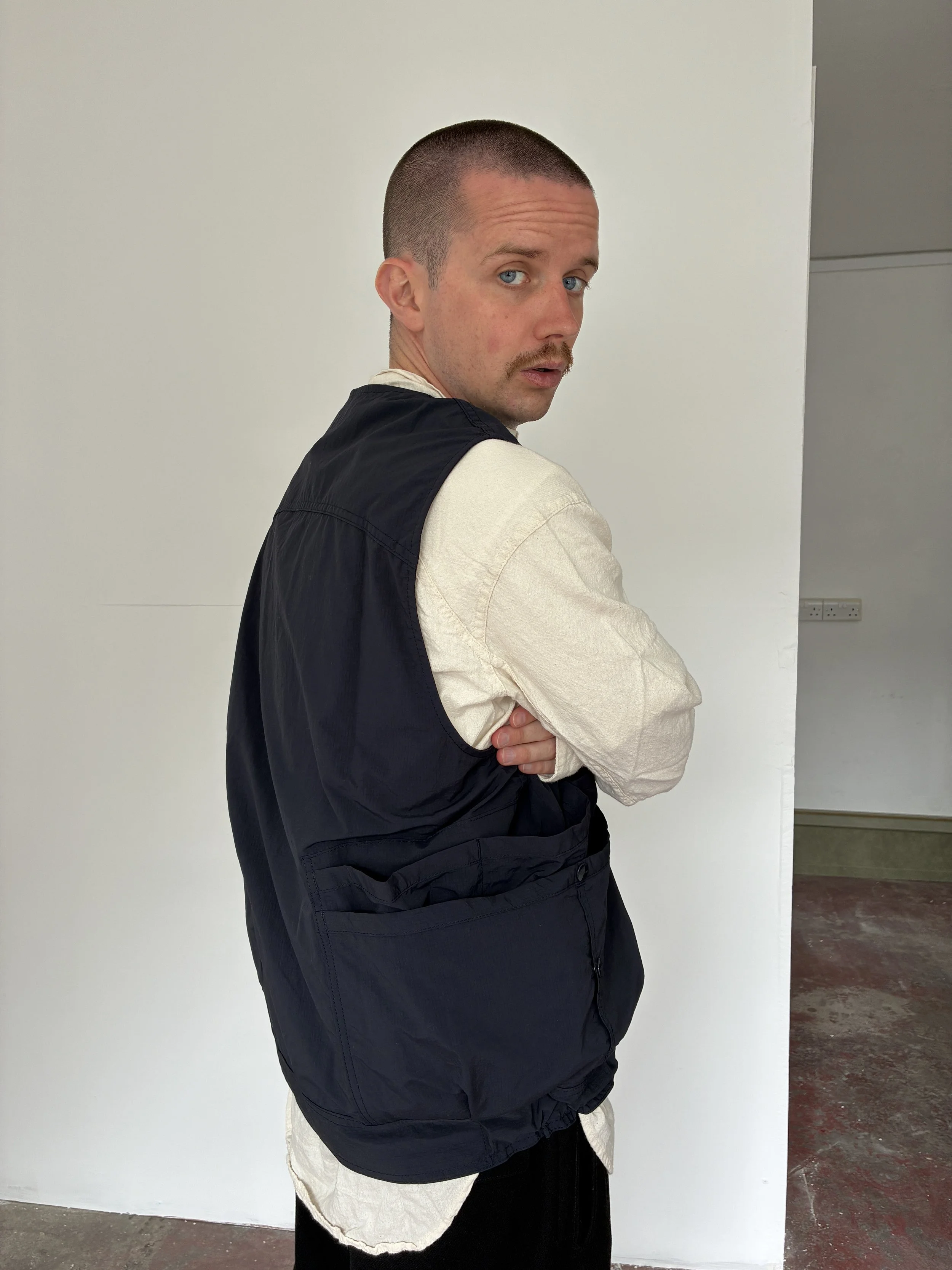 Back of man Man wearing Navy Sassafras Overgrown Hiker Vest
