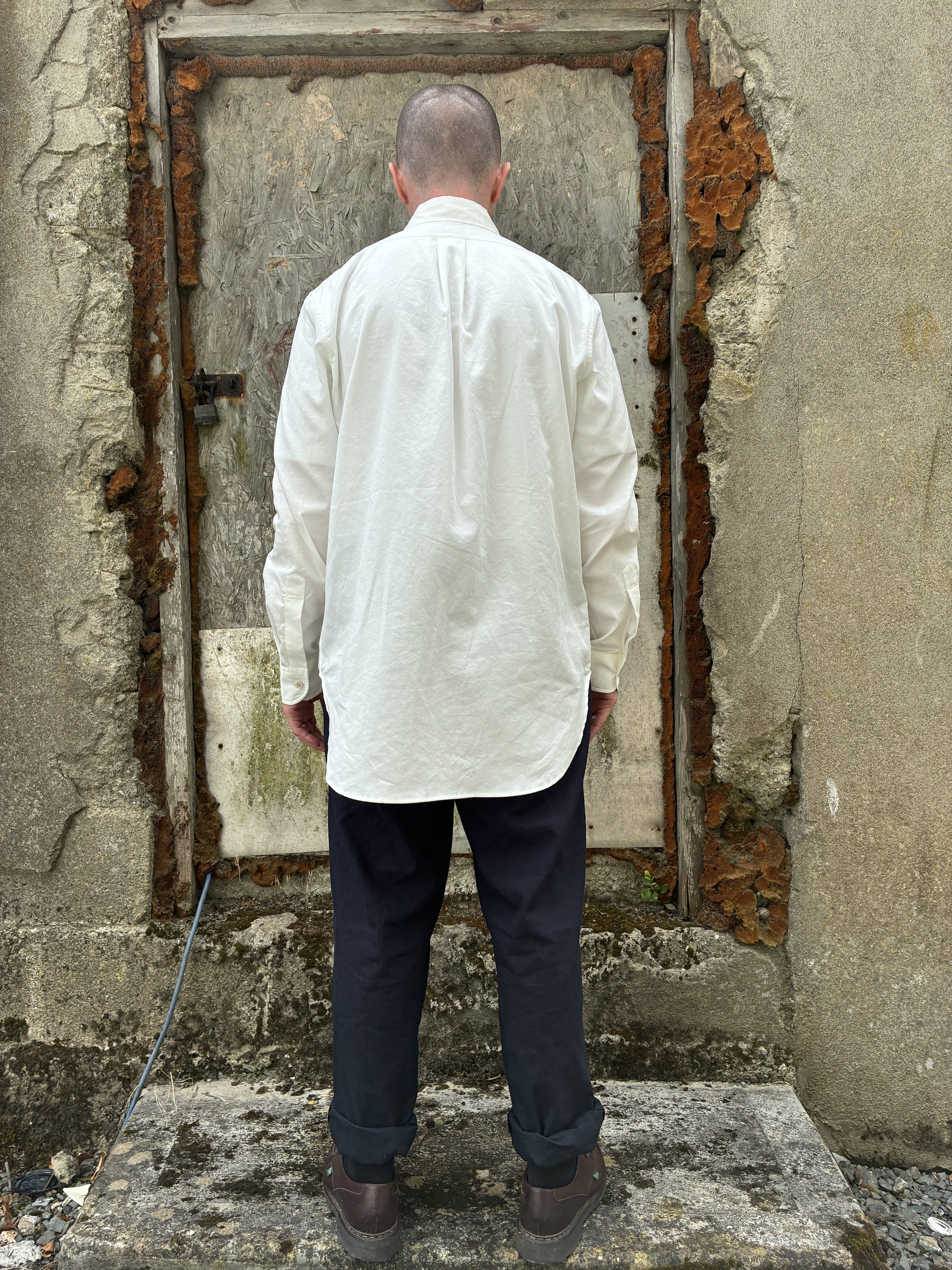 Back of Man in front of wall wearing White 1st PAT-RN Boston Shirt