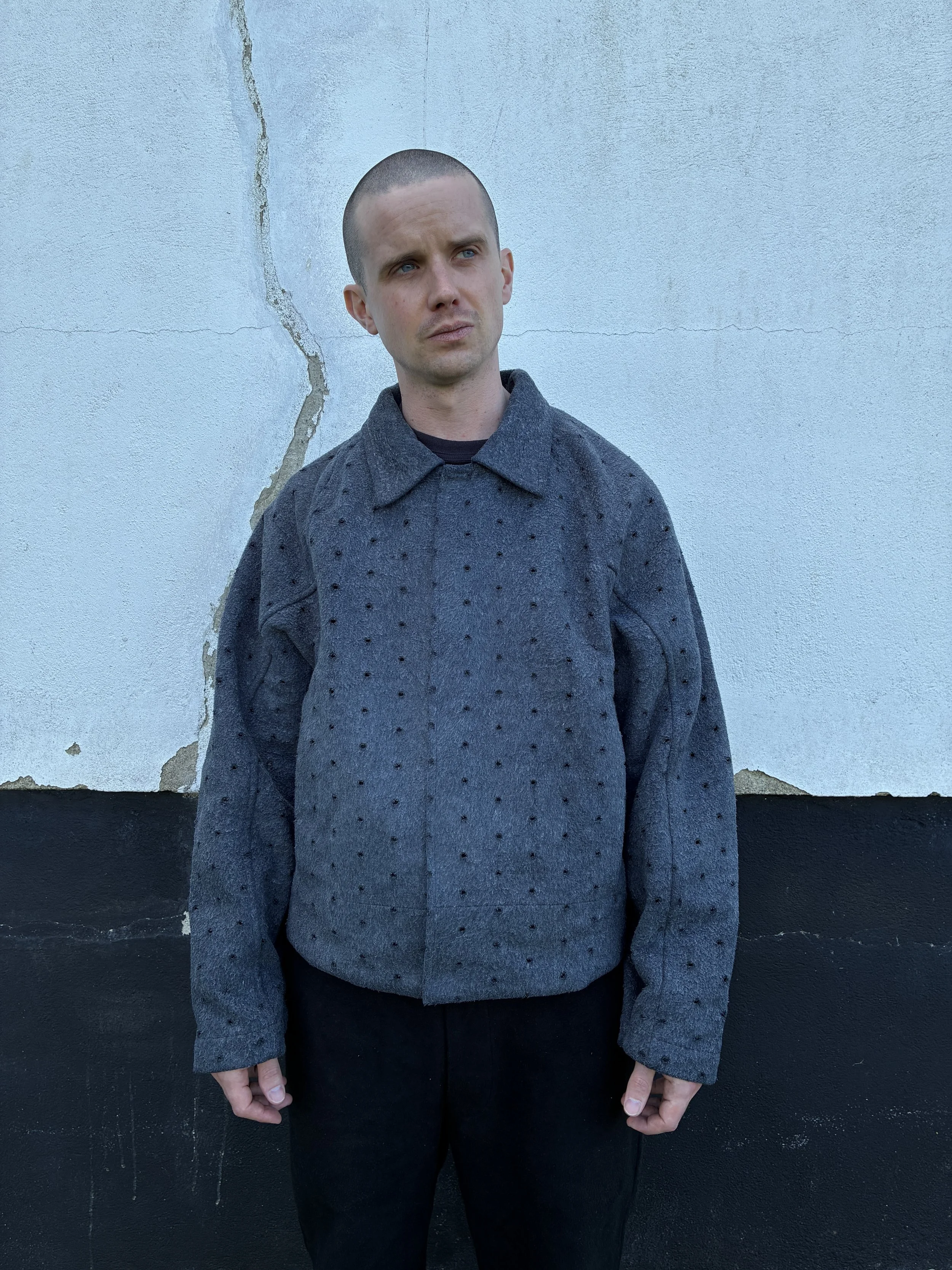 Man outside wearing Middle Distance grey Drill jacket