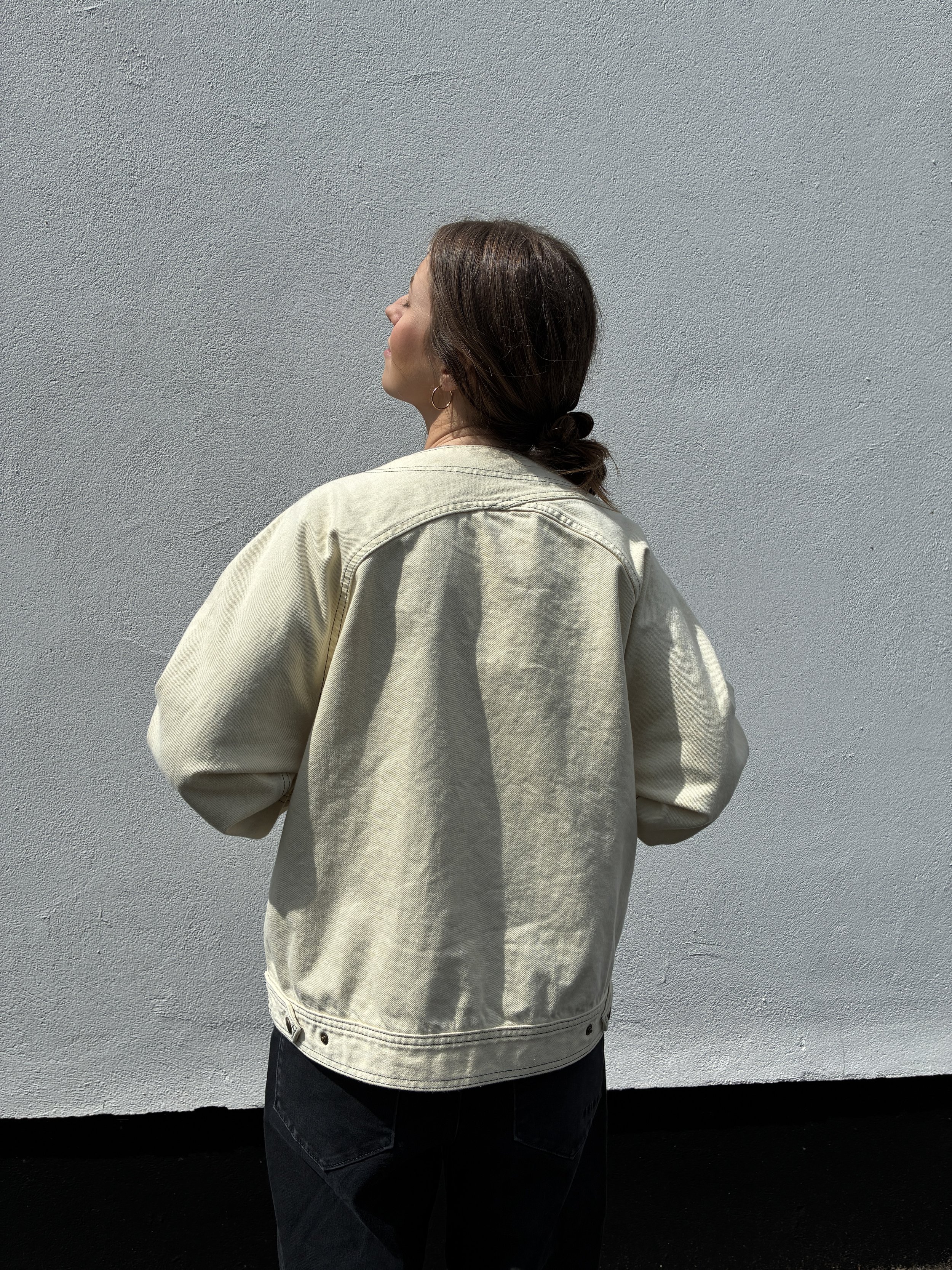 Back of woman wearing Working Skewed yeast jacket