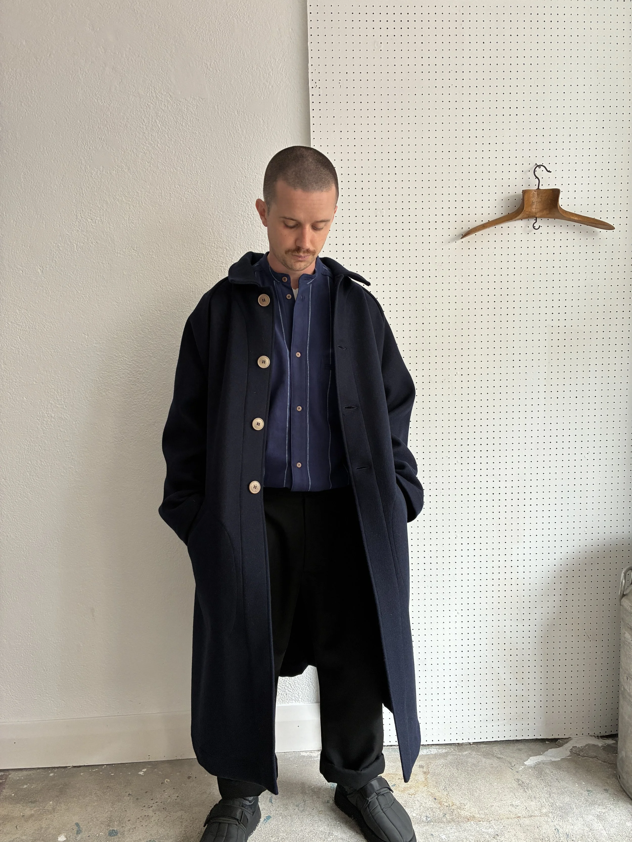 Model wears Frank Leder Navy Wool Duster Coat, front profile view