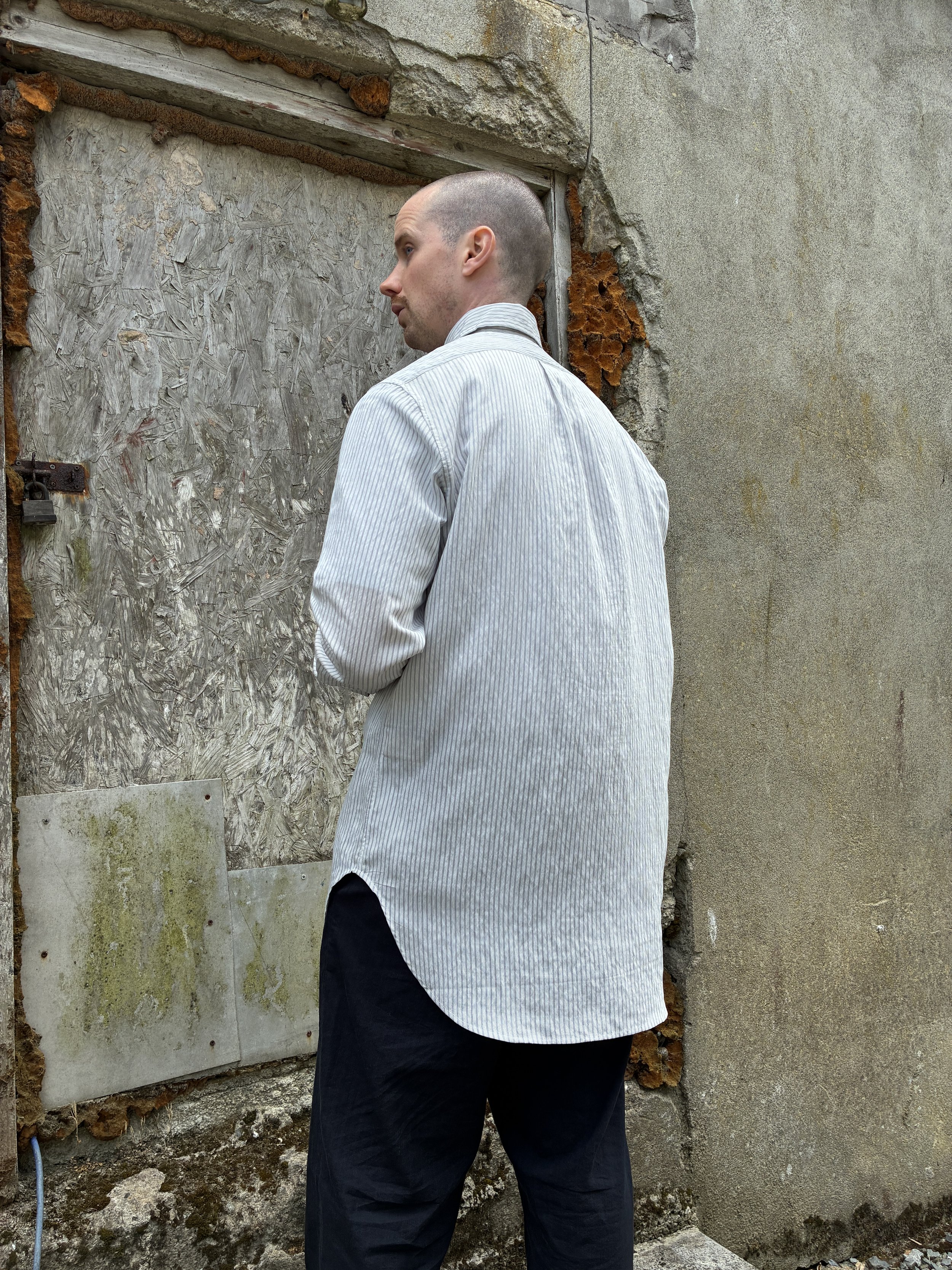 Back of Man in front of wall wearing 1st PAT-RN Boston Shirt in Fine Stripes