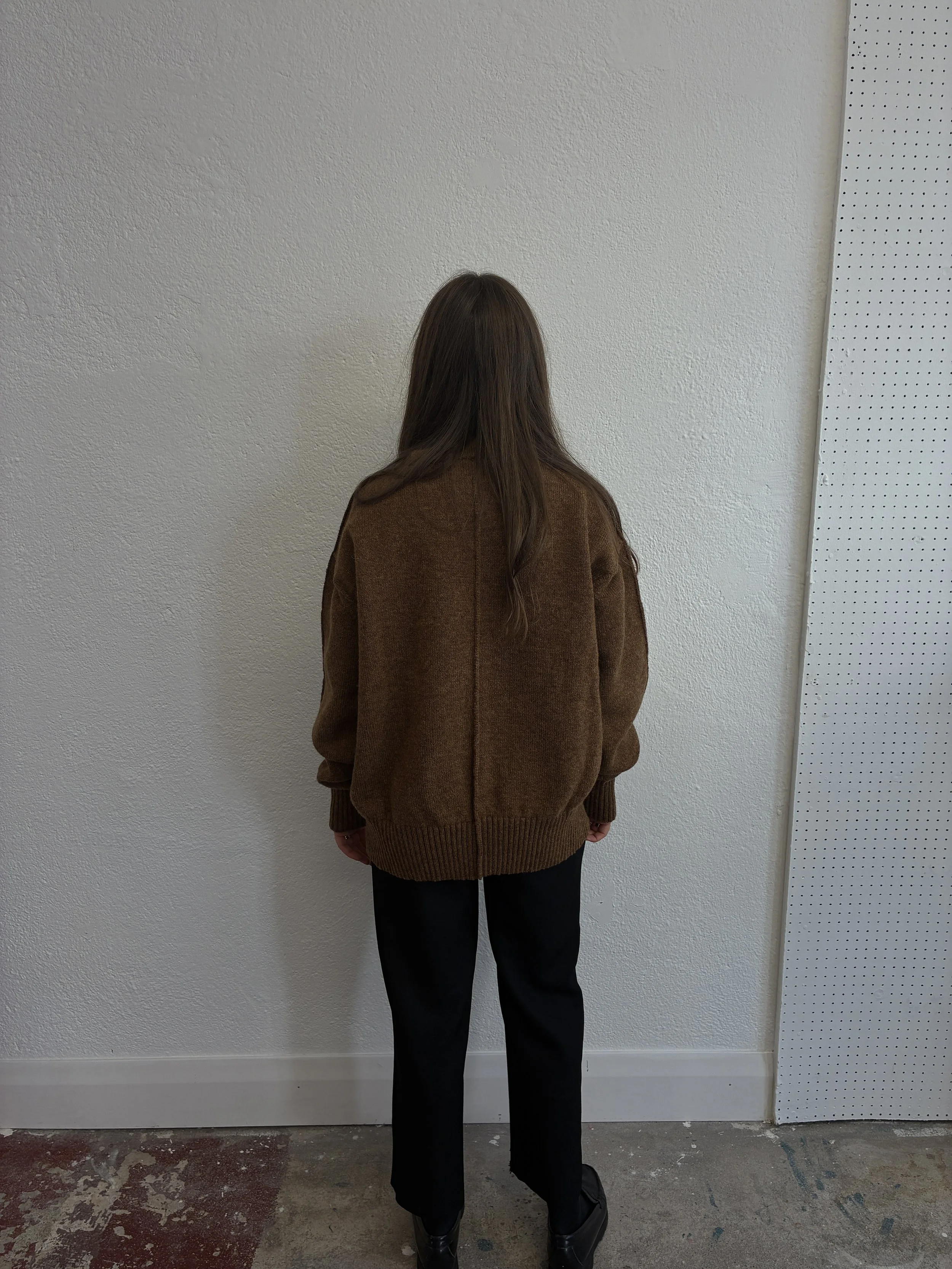 Back of Woman in front of wall wearing Brown Tender Co Type 719 Butterfly Jumper