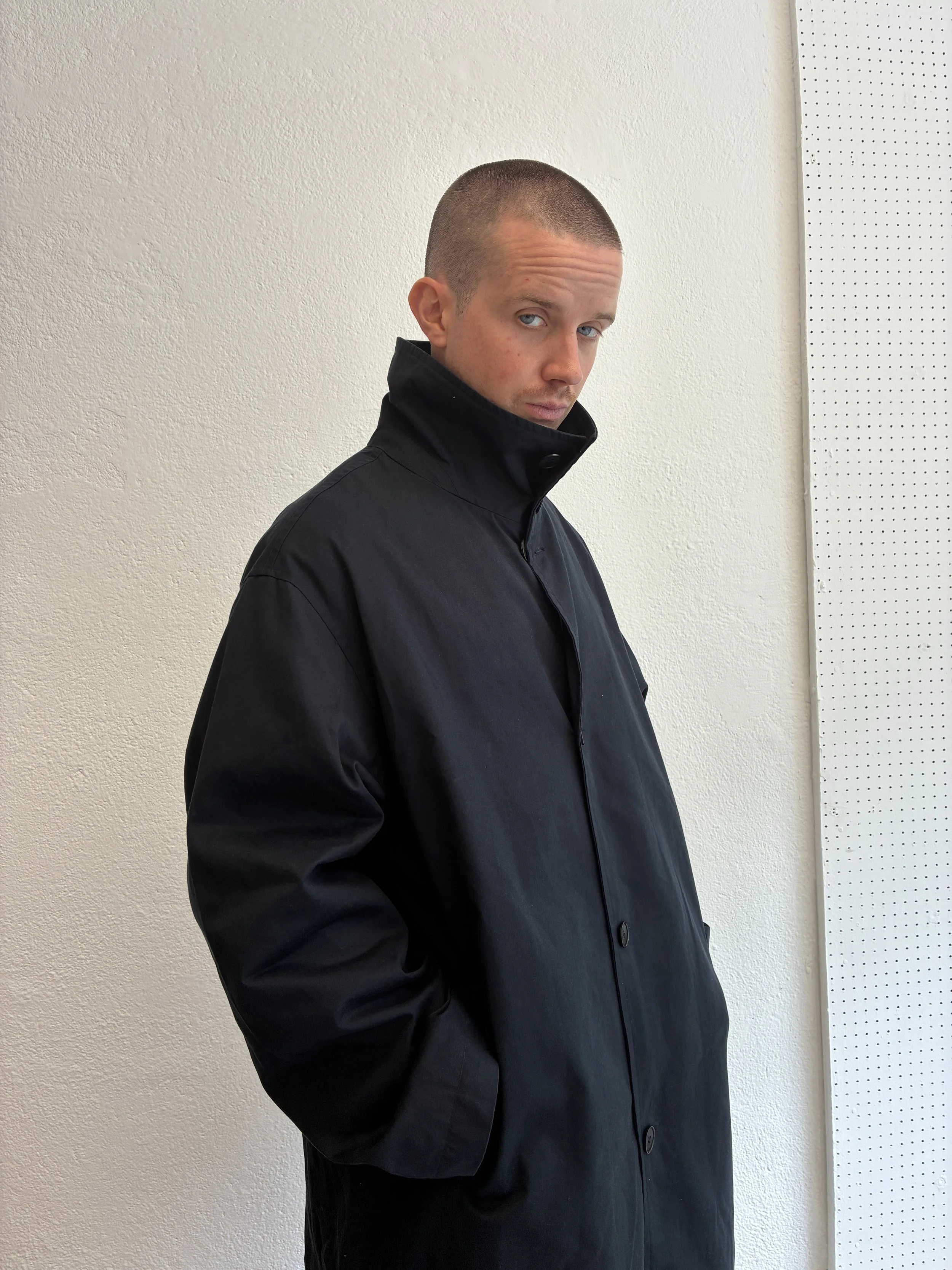 Side profile of man wearing Navy De Dam Foundation Cotton Gabardine Trench Coat