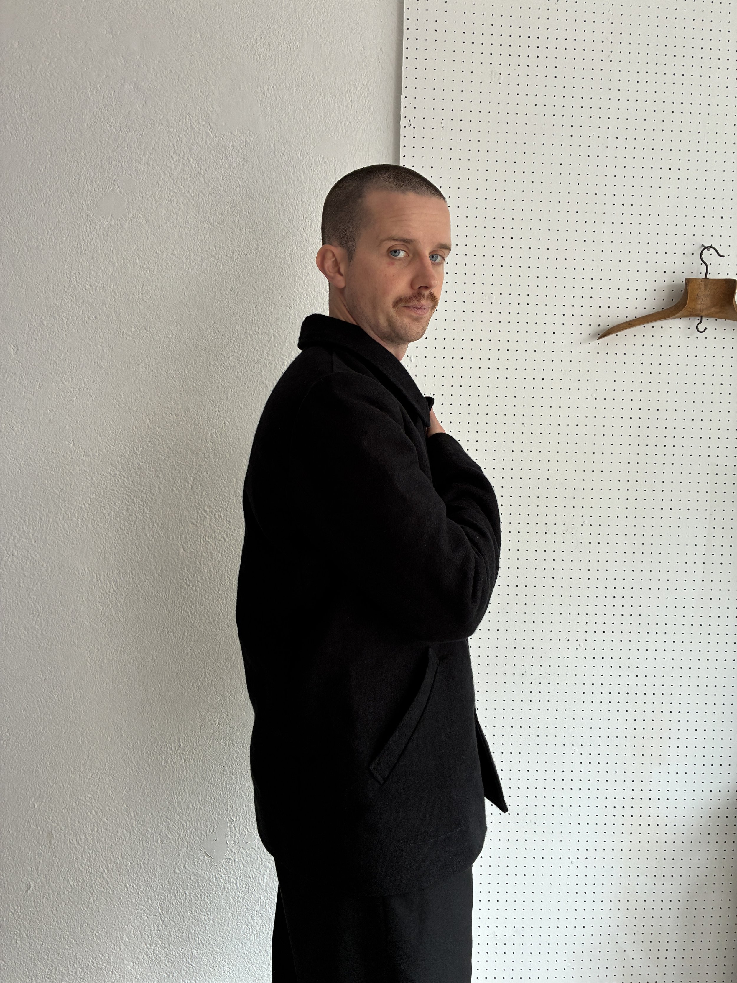 Model wears Black Frank Leder Deutschleder Jacket, side profile