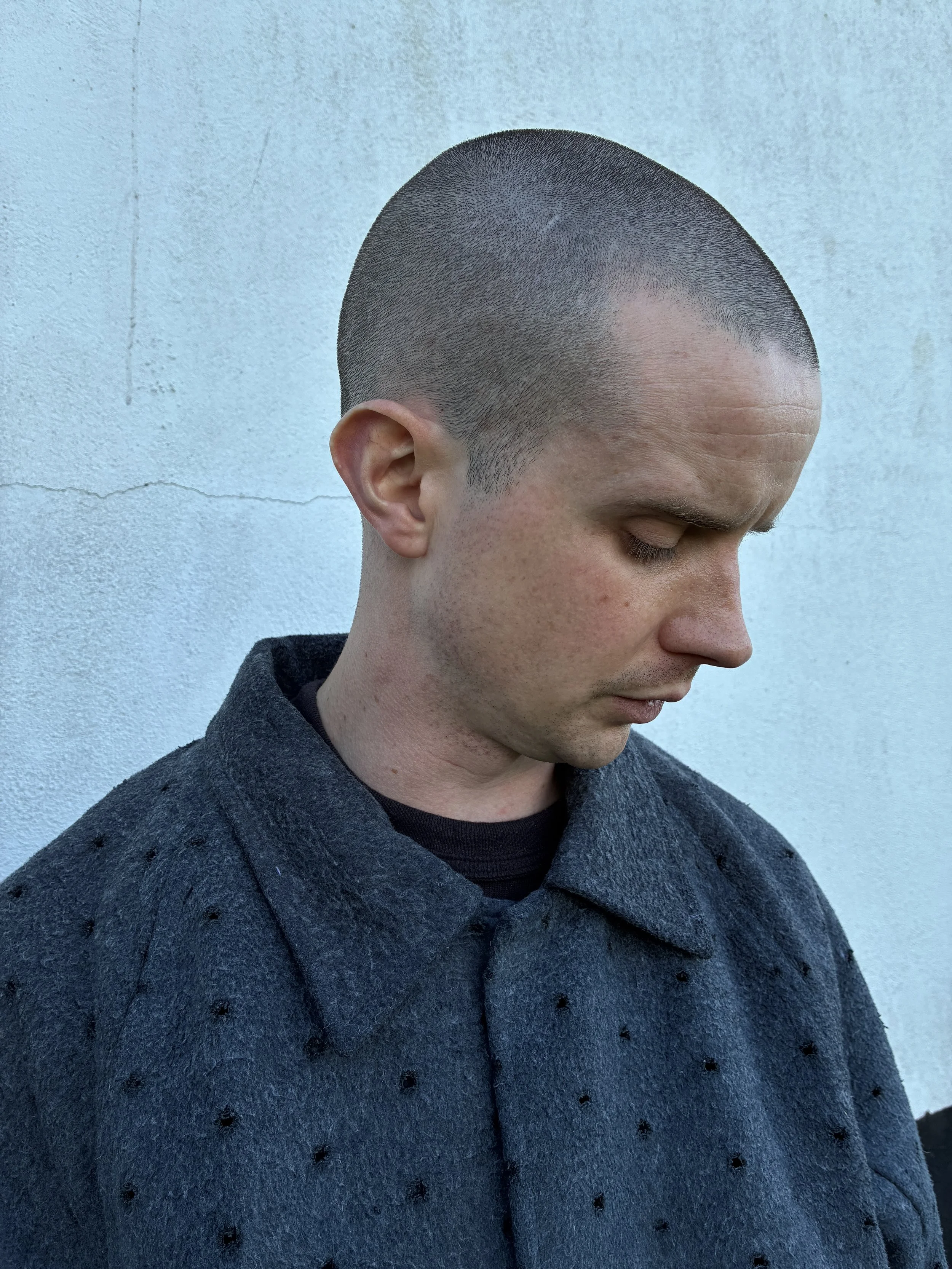 Closeup of man outside wearing Middle Distance grey Drill jacket