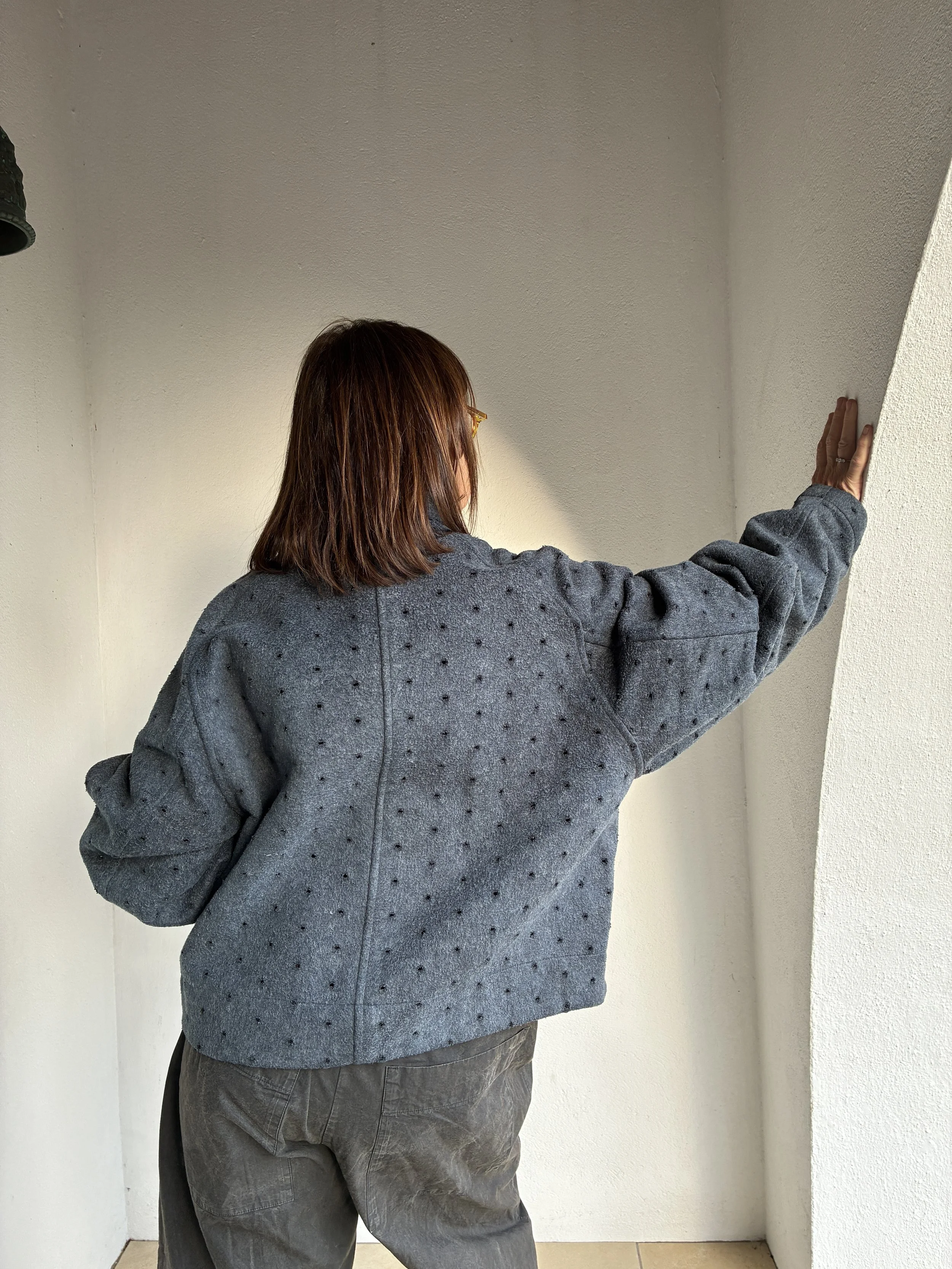 Back of woman outside wearing Middle Distance grey Drill jacket