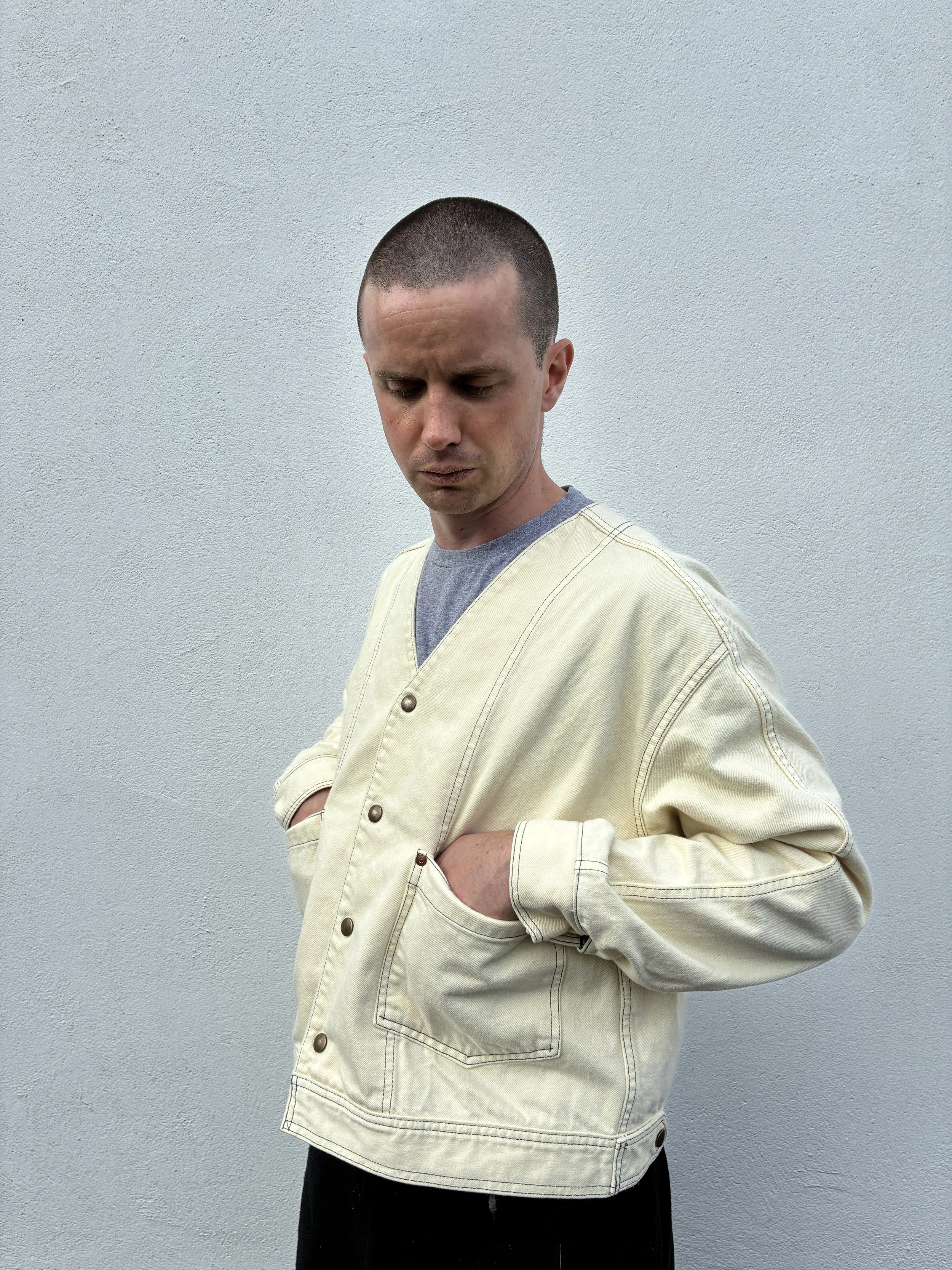 Side profile of man outside wearing Working Skewed yeast jacket