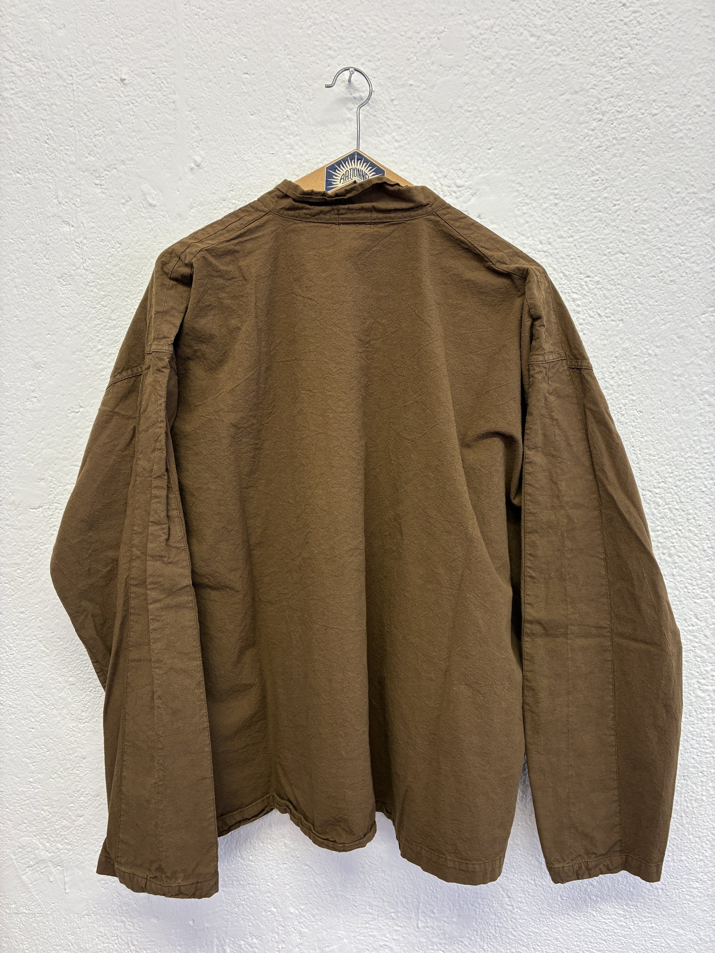 Back of Tender Co Type 485 Isosceles Brown Hat Shirt  on hanger