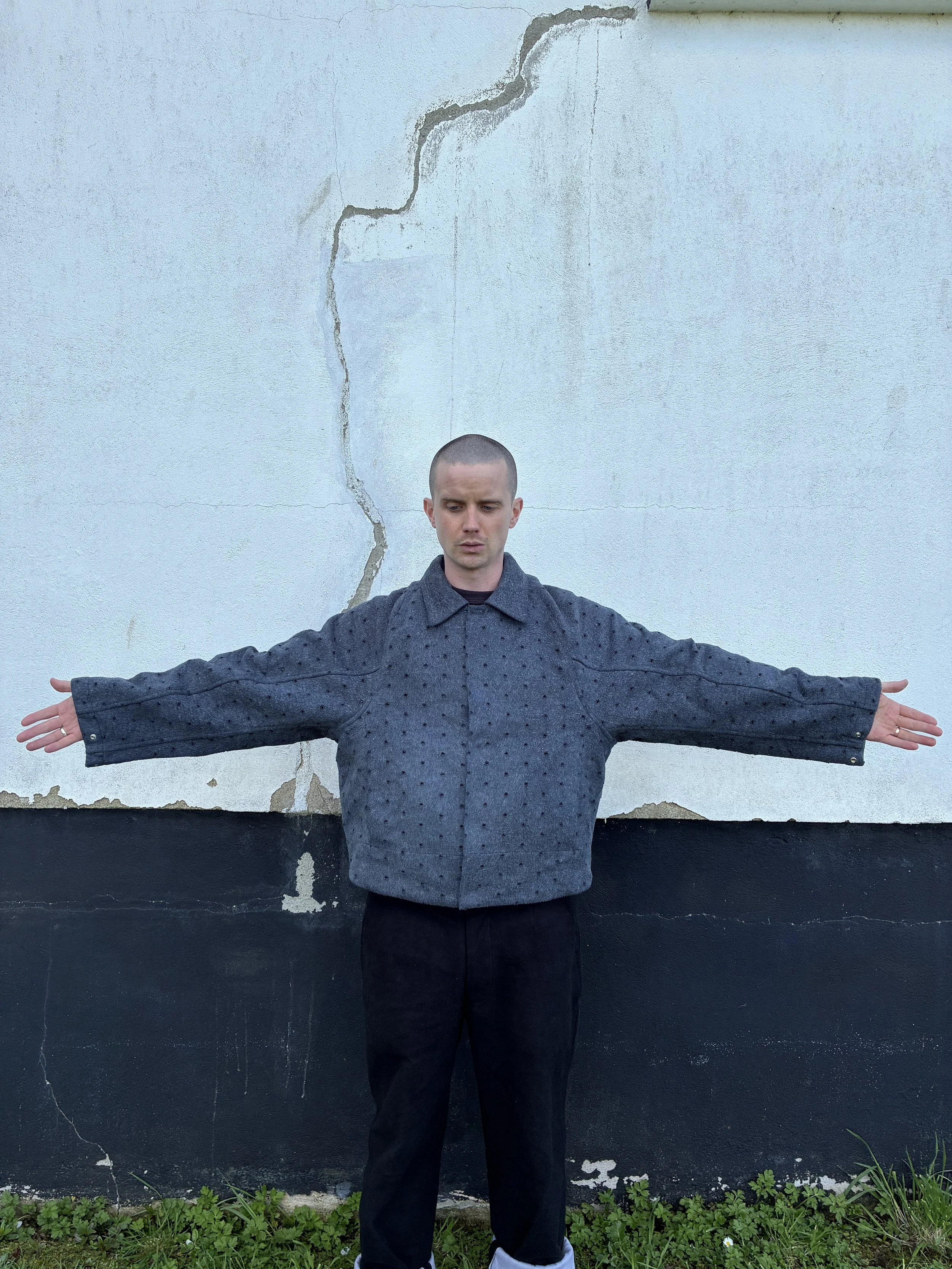Man outside modelling Middle Distance grey Drill jacket