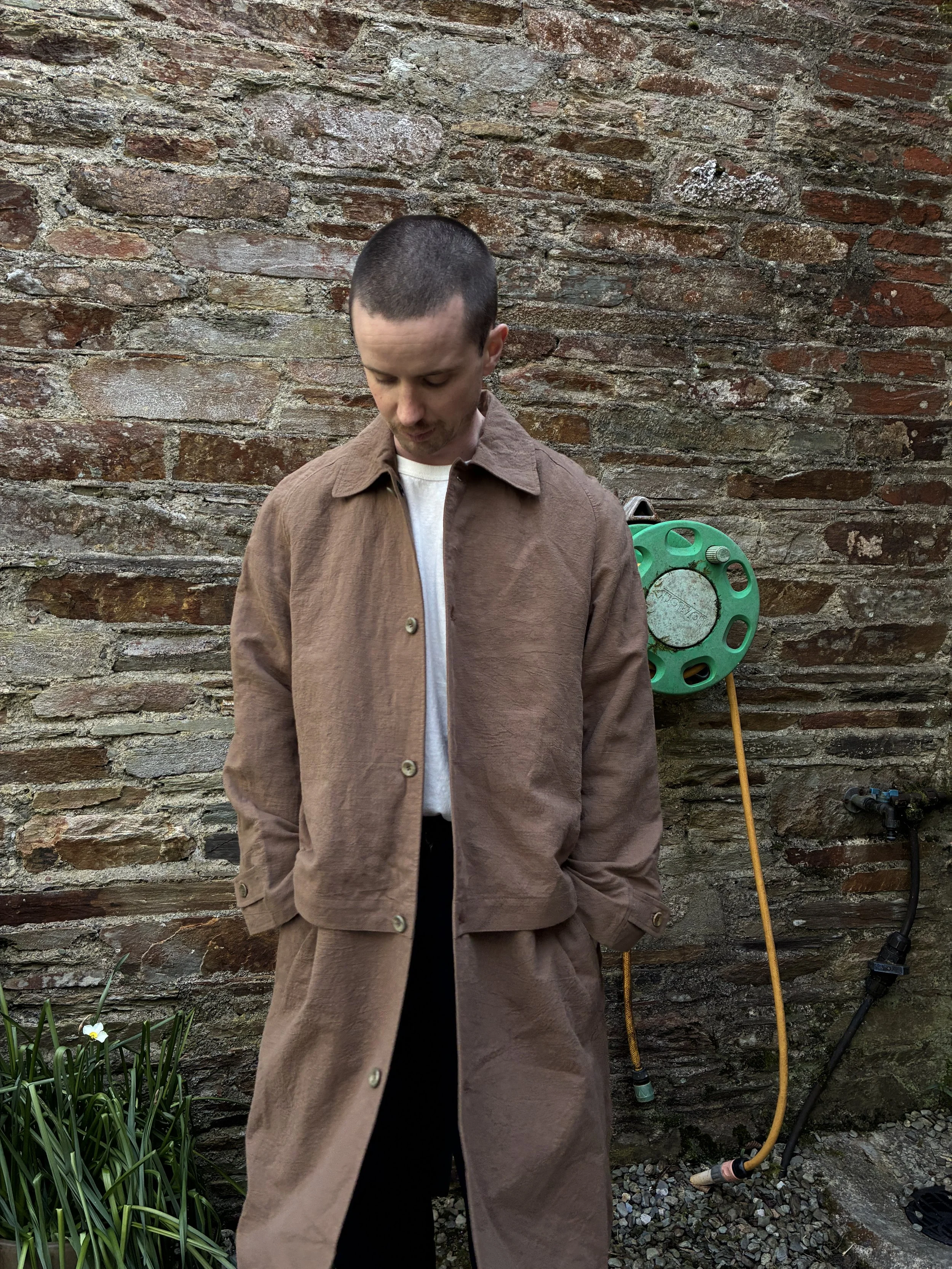Man in front of wall wearing Frank Leder Reversible Coat in Brown