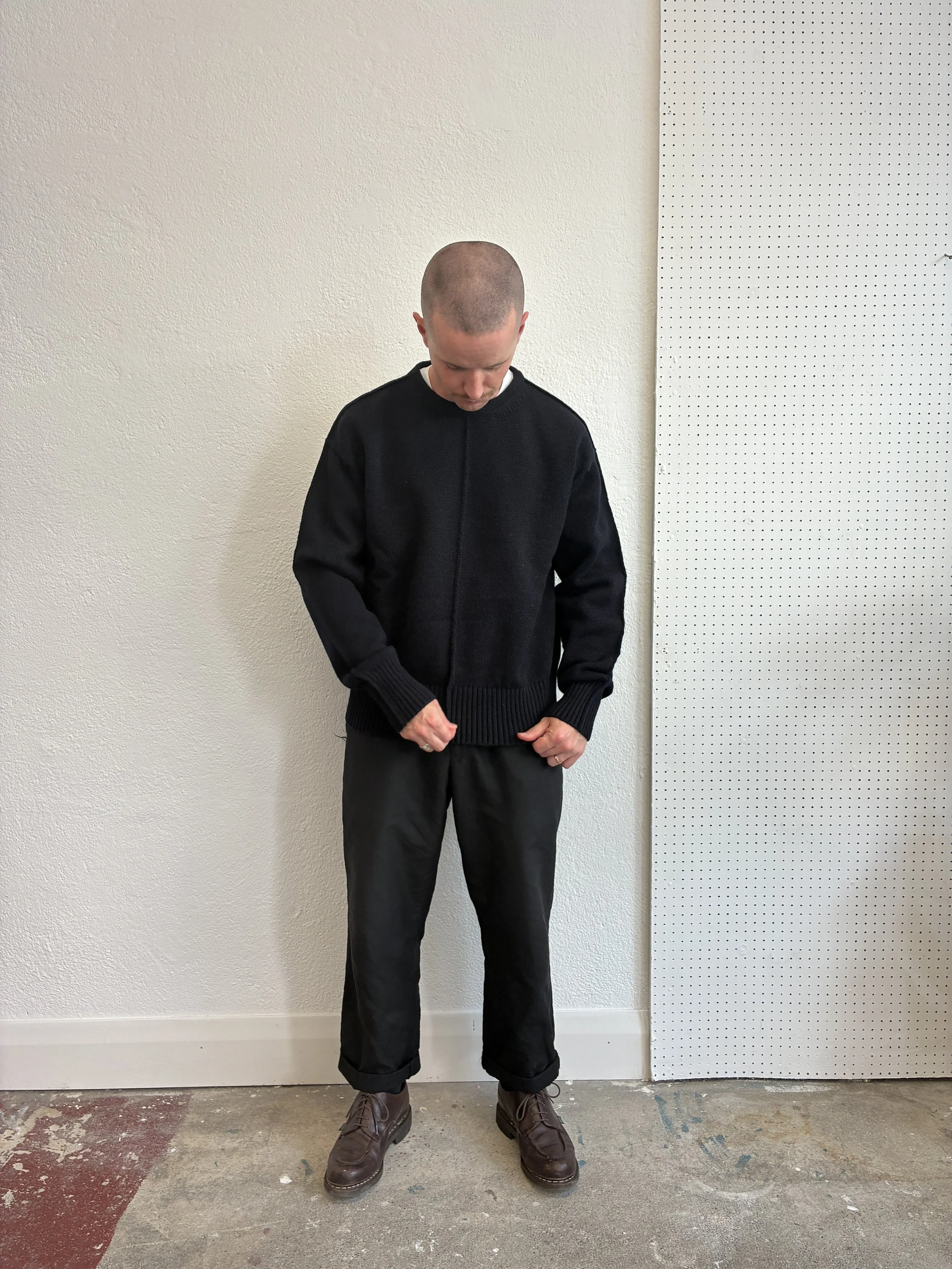 Man in front of wall wearing Navy Tender Co Type 719 Butterfly Jumper