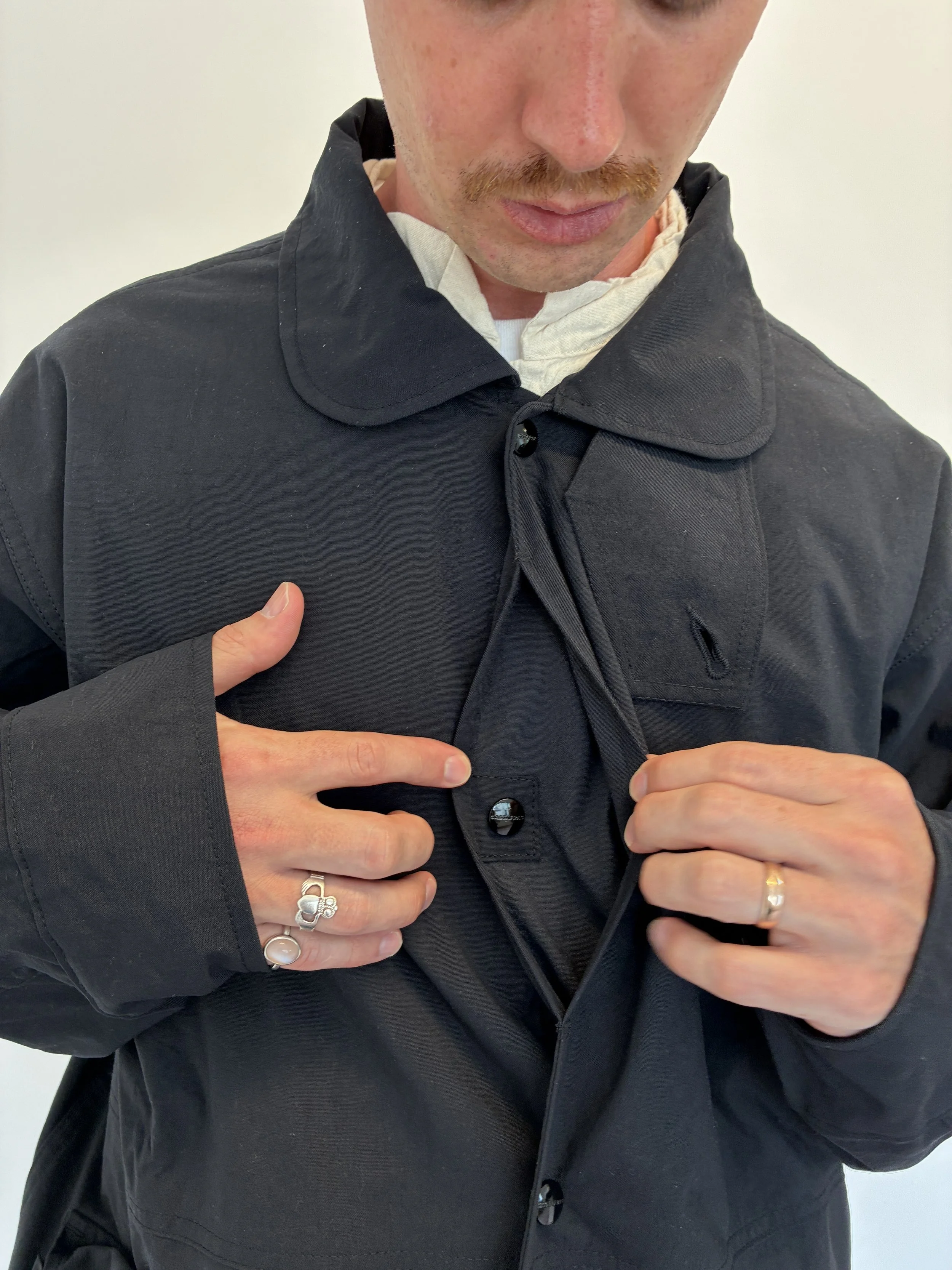 Man showing close up of buttons on Black Sassafras Cultivator Coat