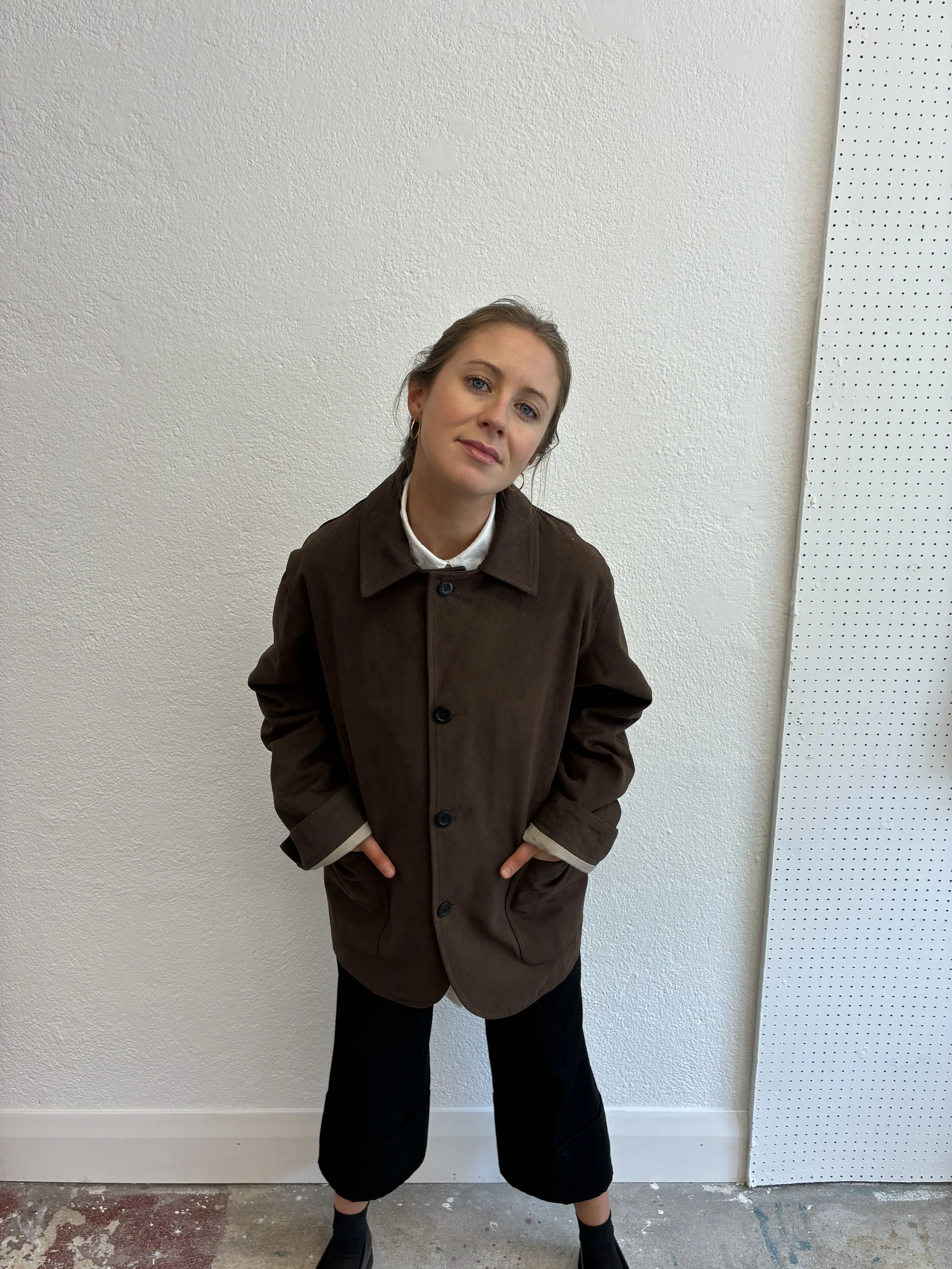 Woman posing in front of wall in Brown Conkers Bruton Blazer Jacket