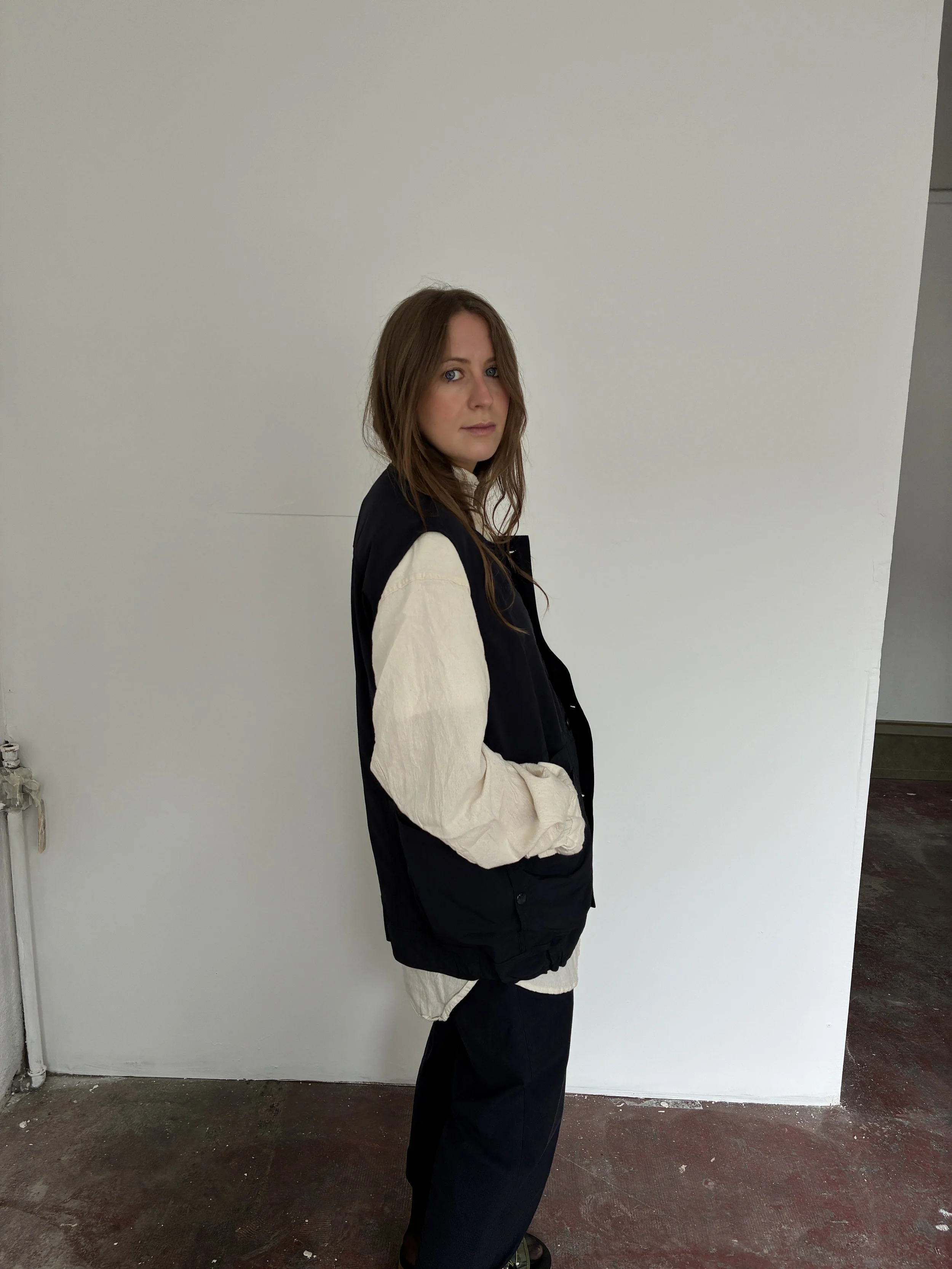 Side of Woman wearing Navy Sassafras Overgrown Hiker Vest