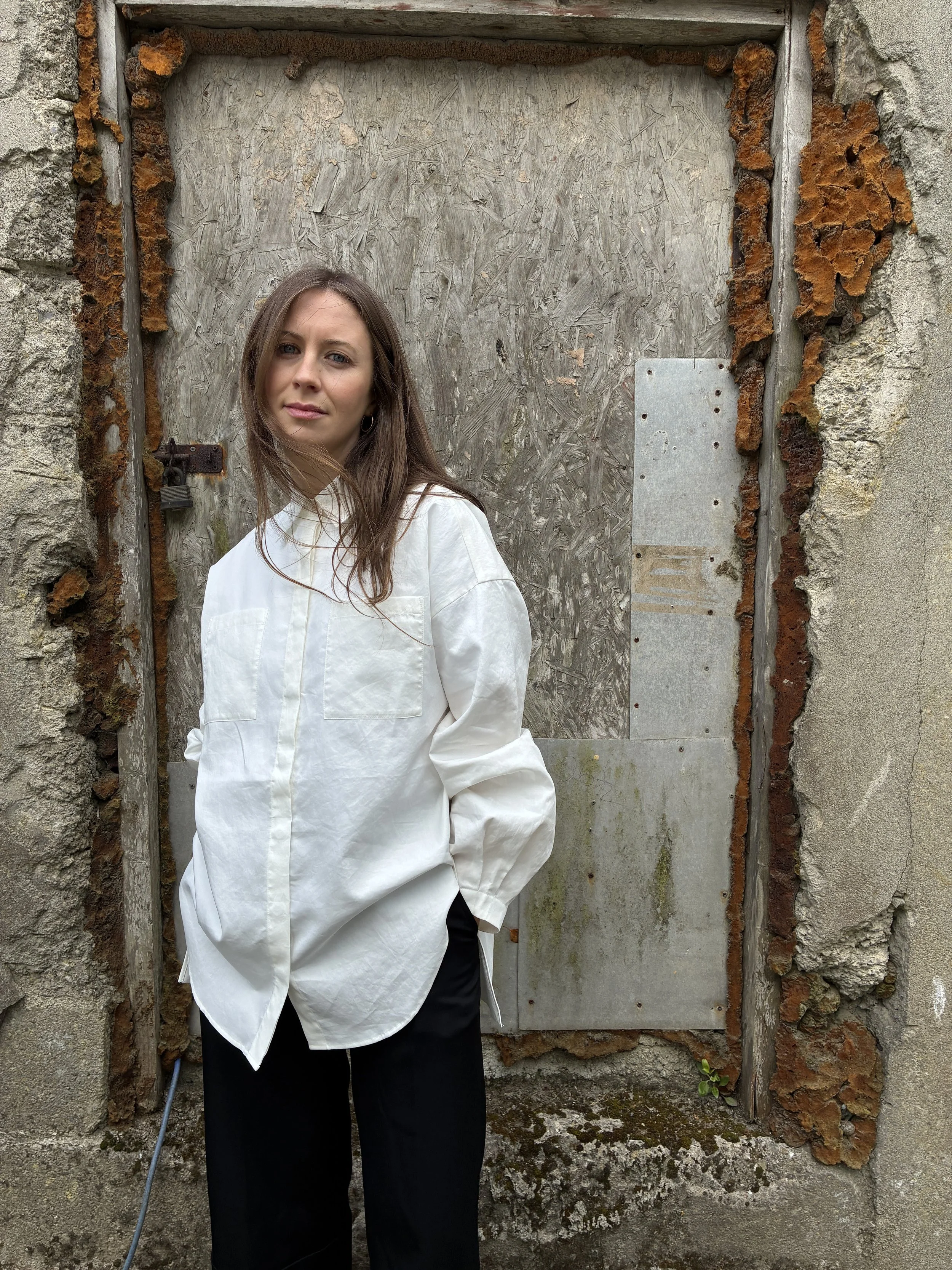 Woman wearing White 1st PAT-RN Woman Modula Shirt with hands in pockets