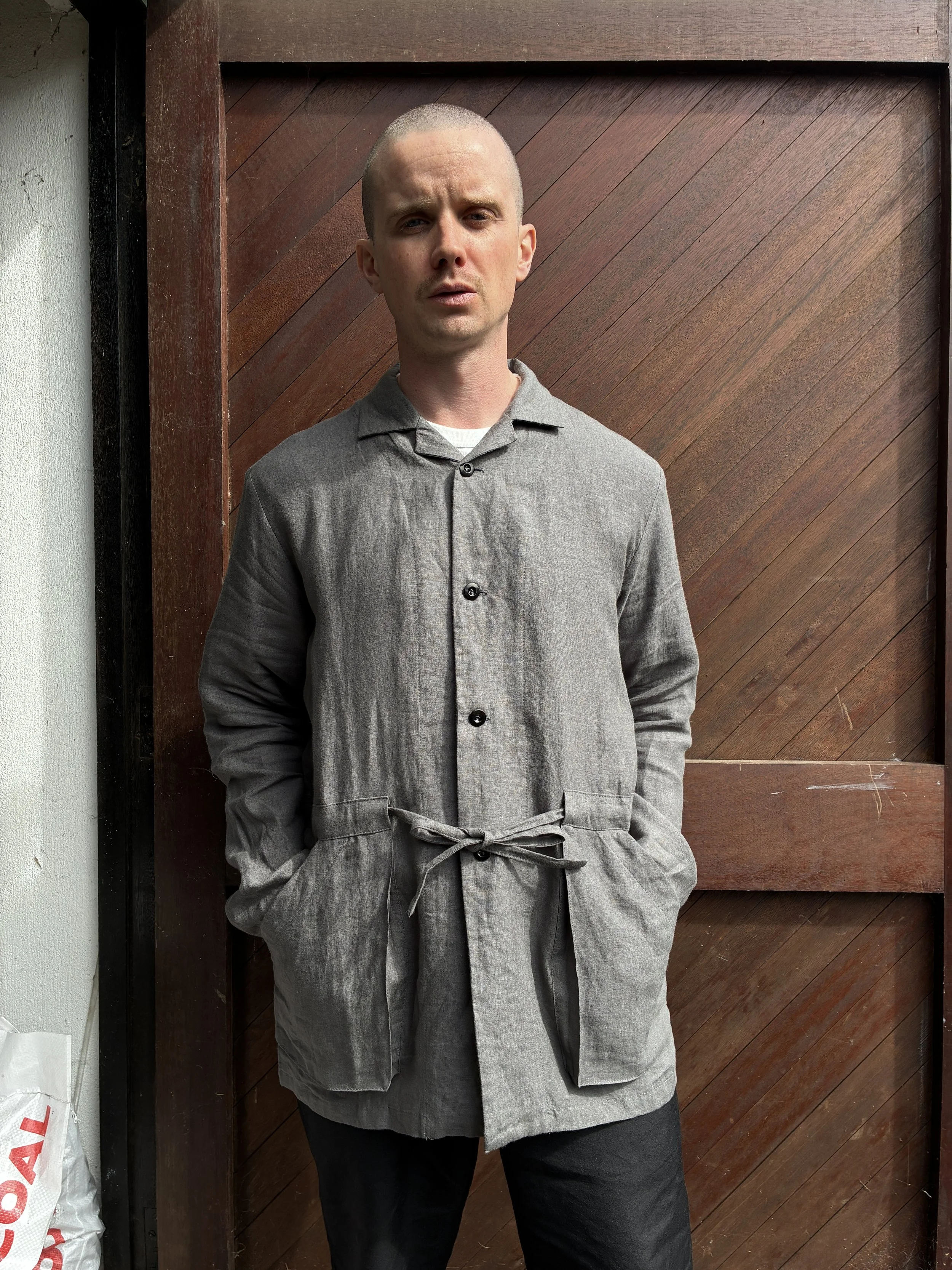 Man in front of wooden door wearing Limited Edition Frank Leder Grey LINDWURM Linen Cardigan