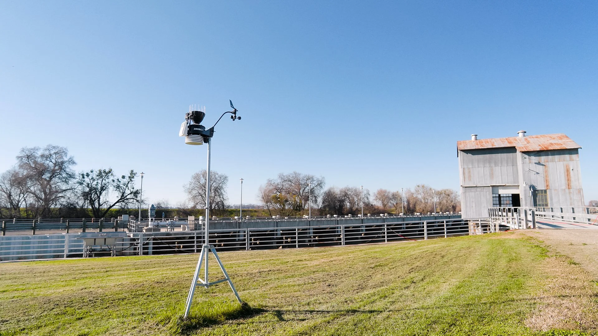 photo of an installed weather station outdoors on a field