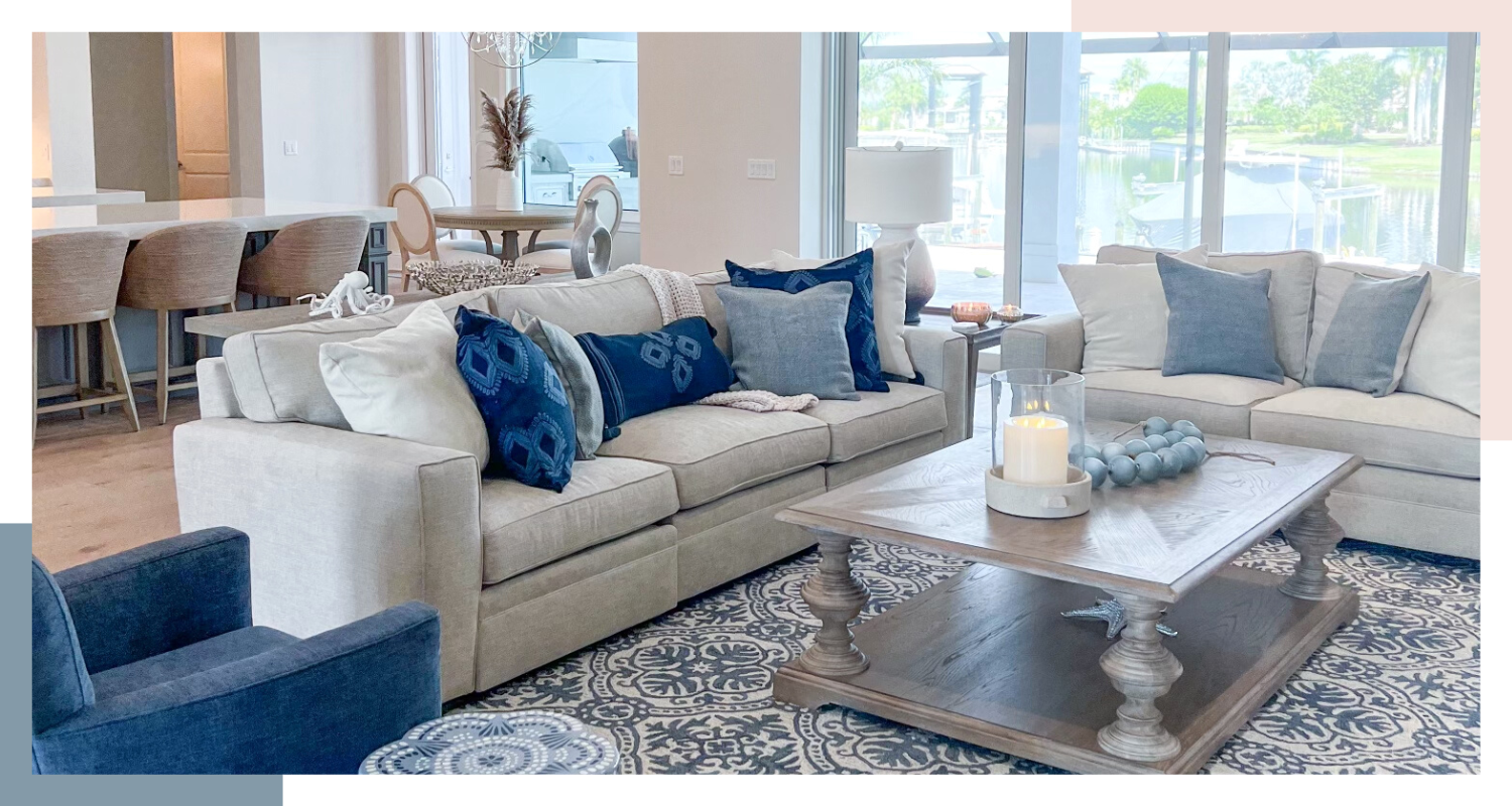 Living room with light grey couch and blue pillows and accents