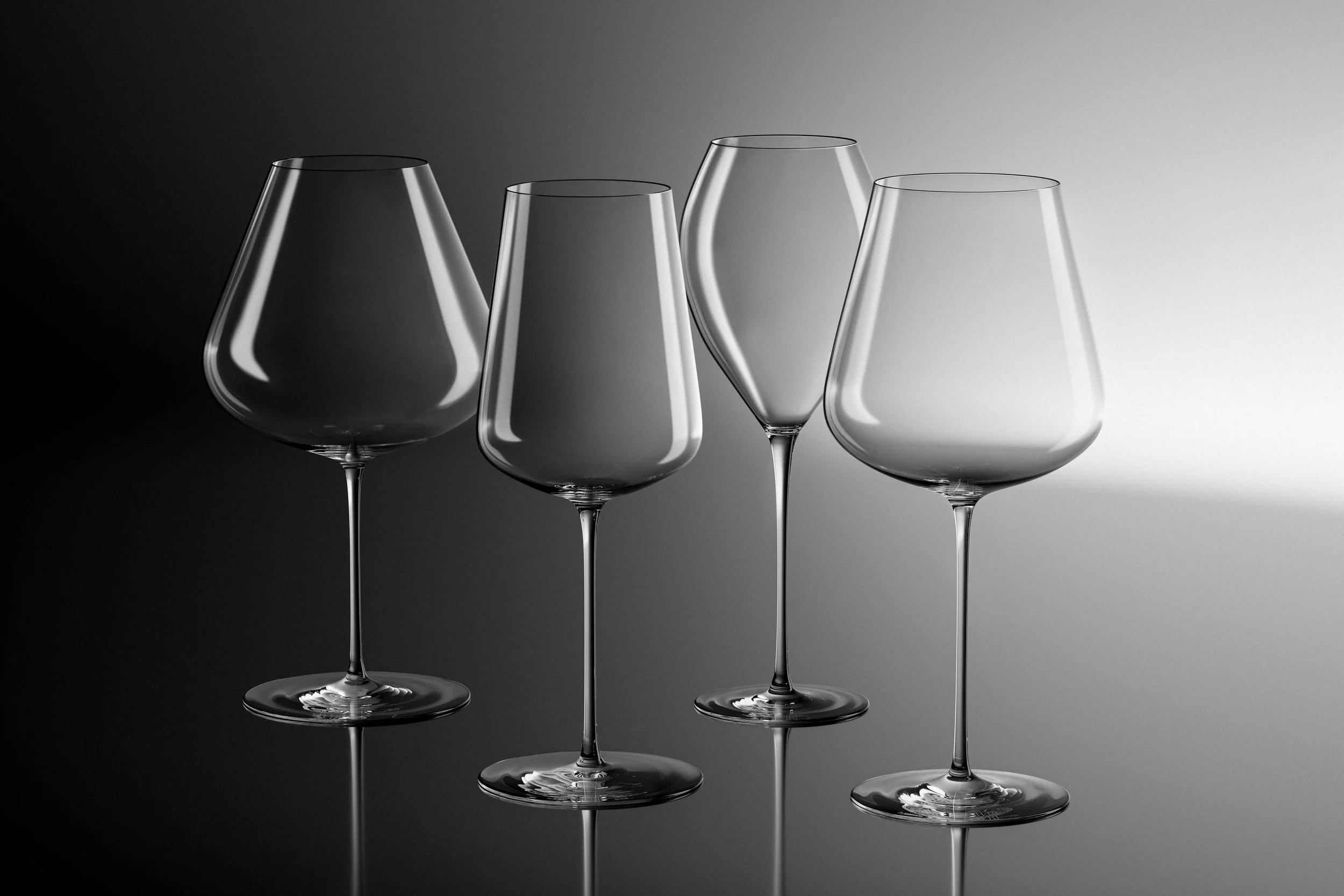 CGI render of the complete SWRL Glass collection of premium handblown crystal stemware, arranged in a stepped pattern on a contrasting gradient backdrop. 