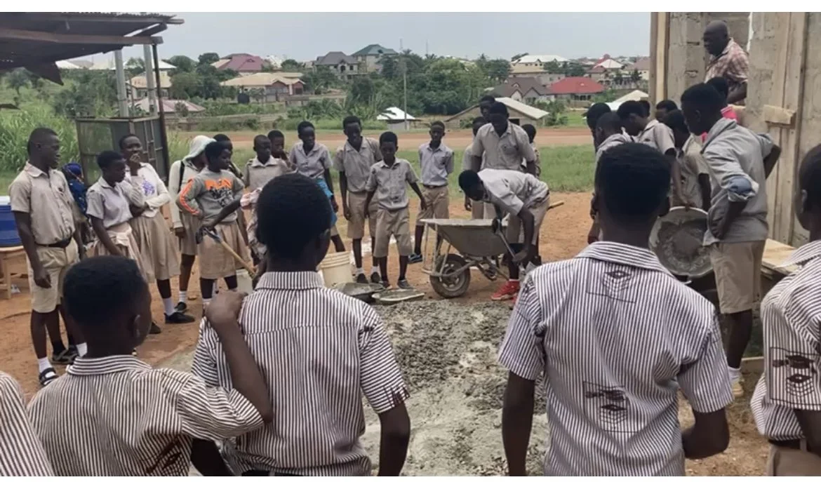 Students helping Mr Offei with construction