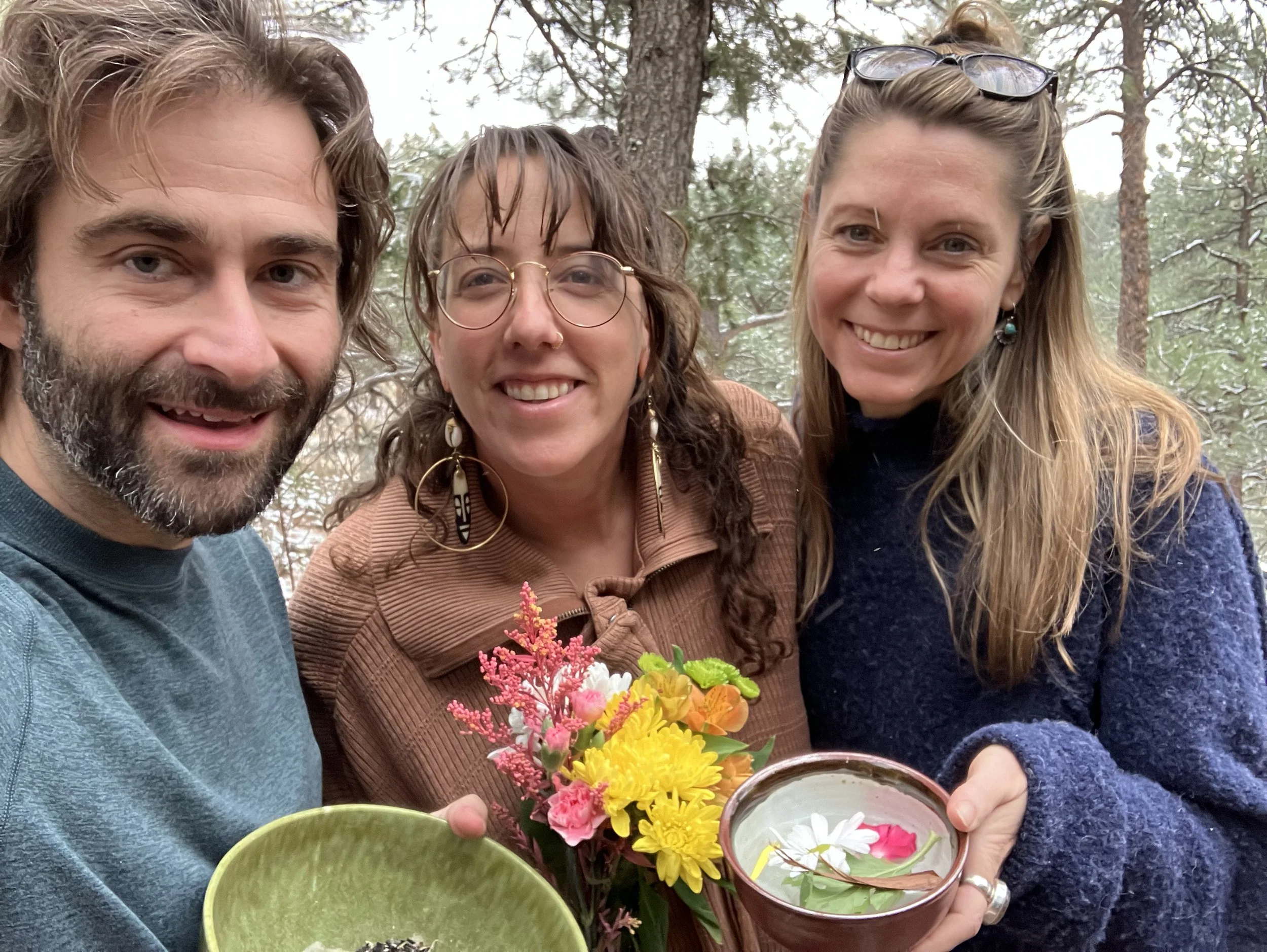 Adam, Naiya, and Cari holding elements from the CCC's death ritual.