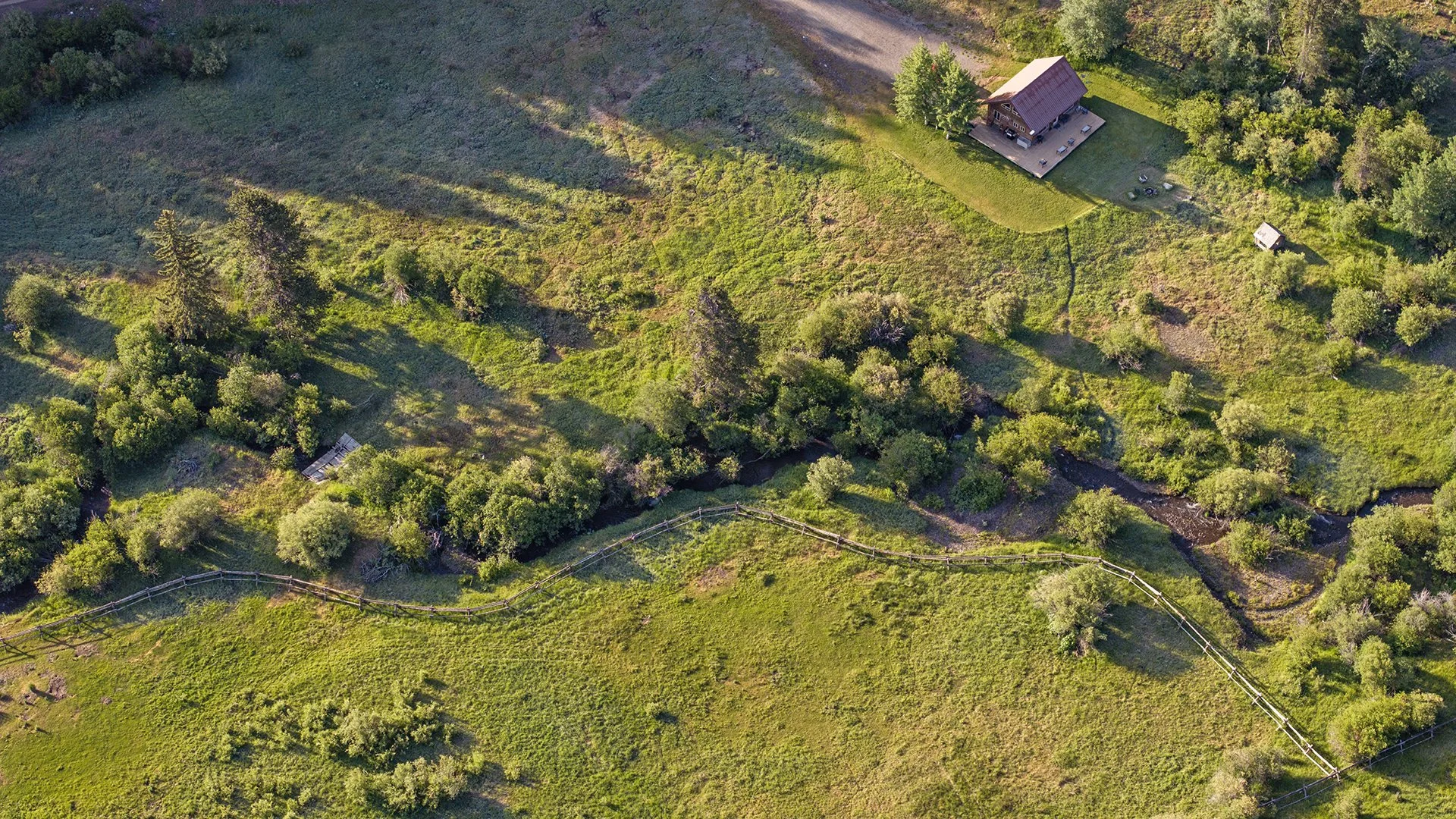 aerial-grandpas-cabin-and-creek-flowing.jpg