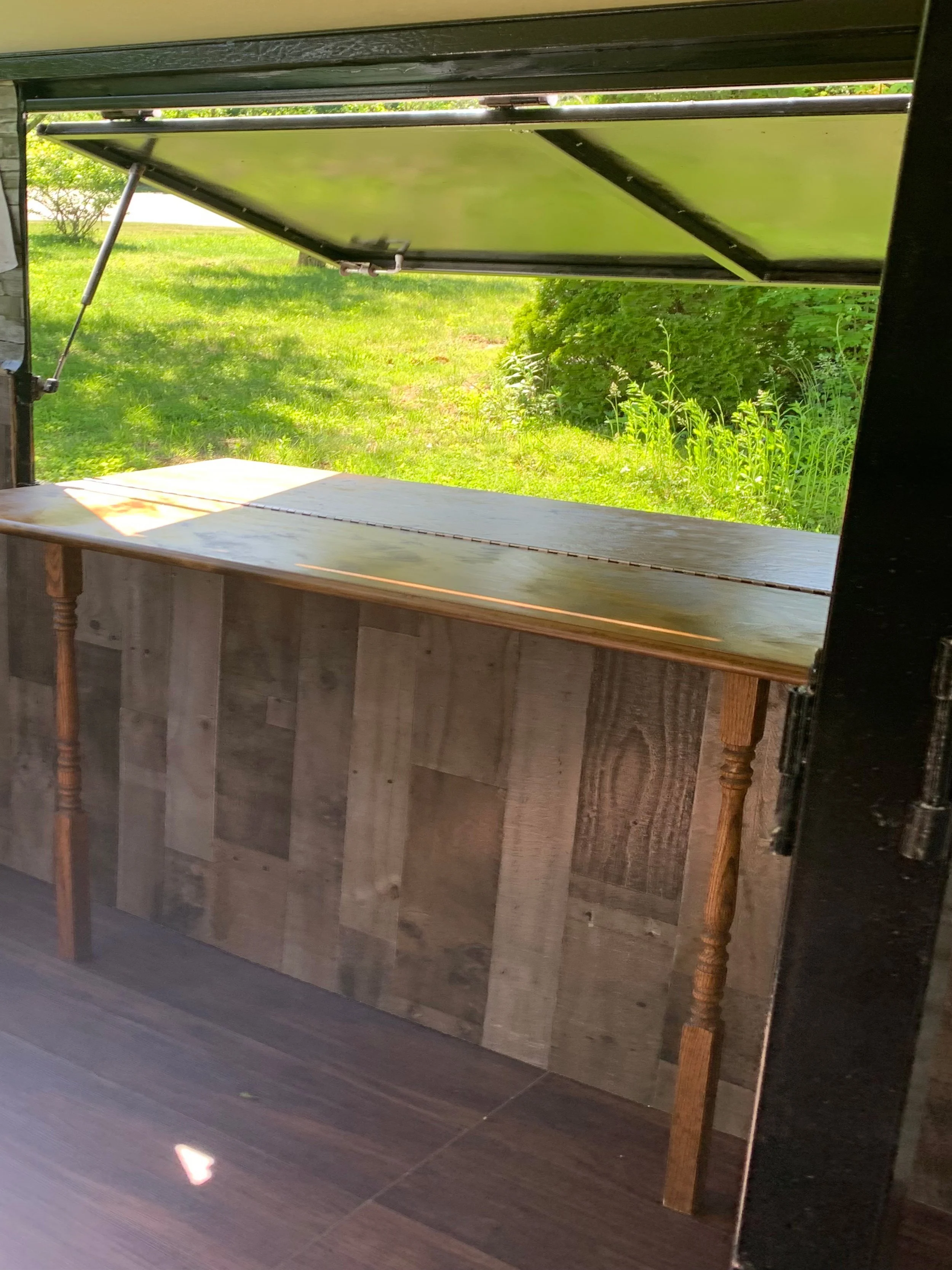Inside view of  event bartending service mobile bar with wooden outfacing bar in Rochester New Hampshire