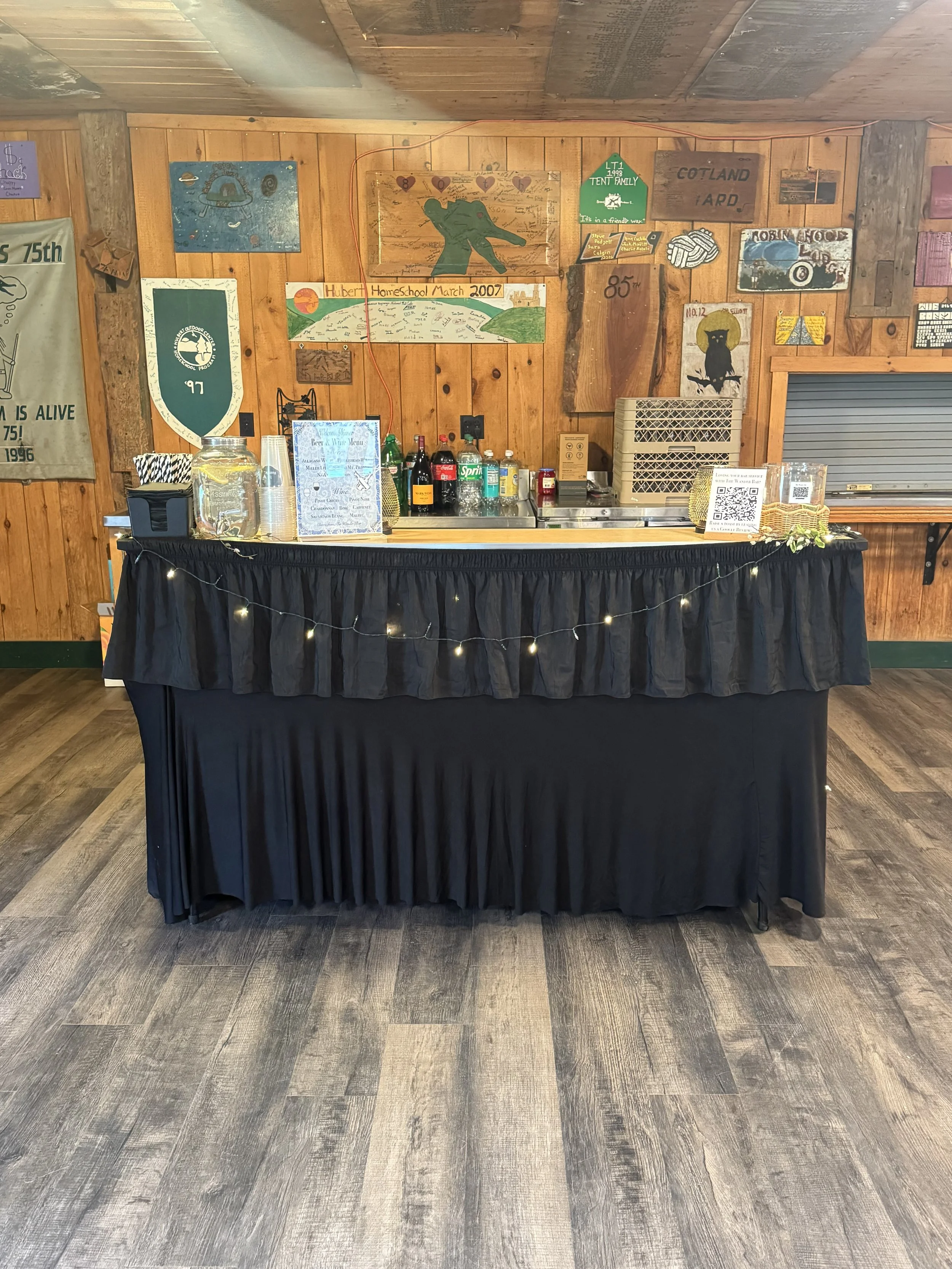 Event bar for Bat Mitvah is set up with black table cloth and fairy lights