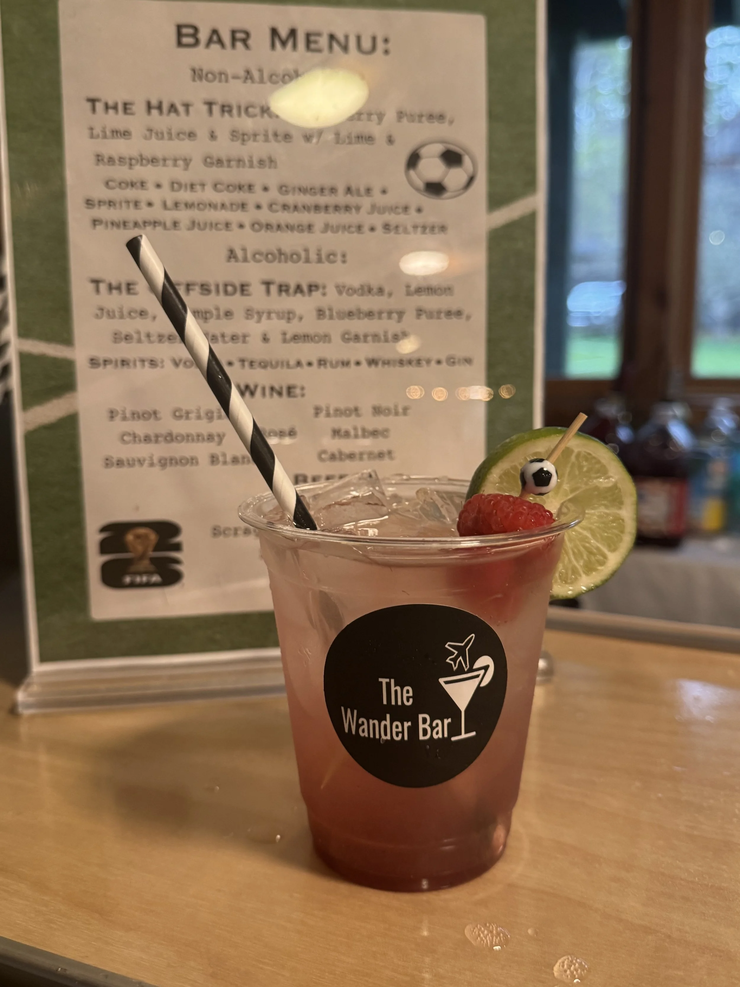 Raspberry Lime Rickey Mocktail sits in front of Bar Menu at Bar Mitvah in Vermont