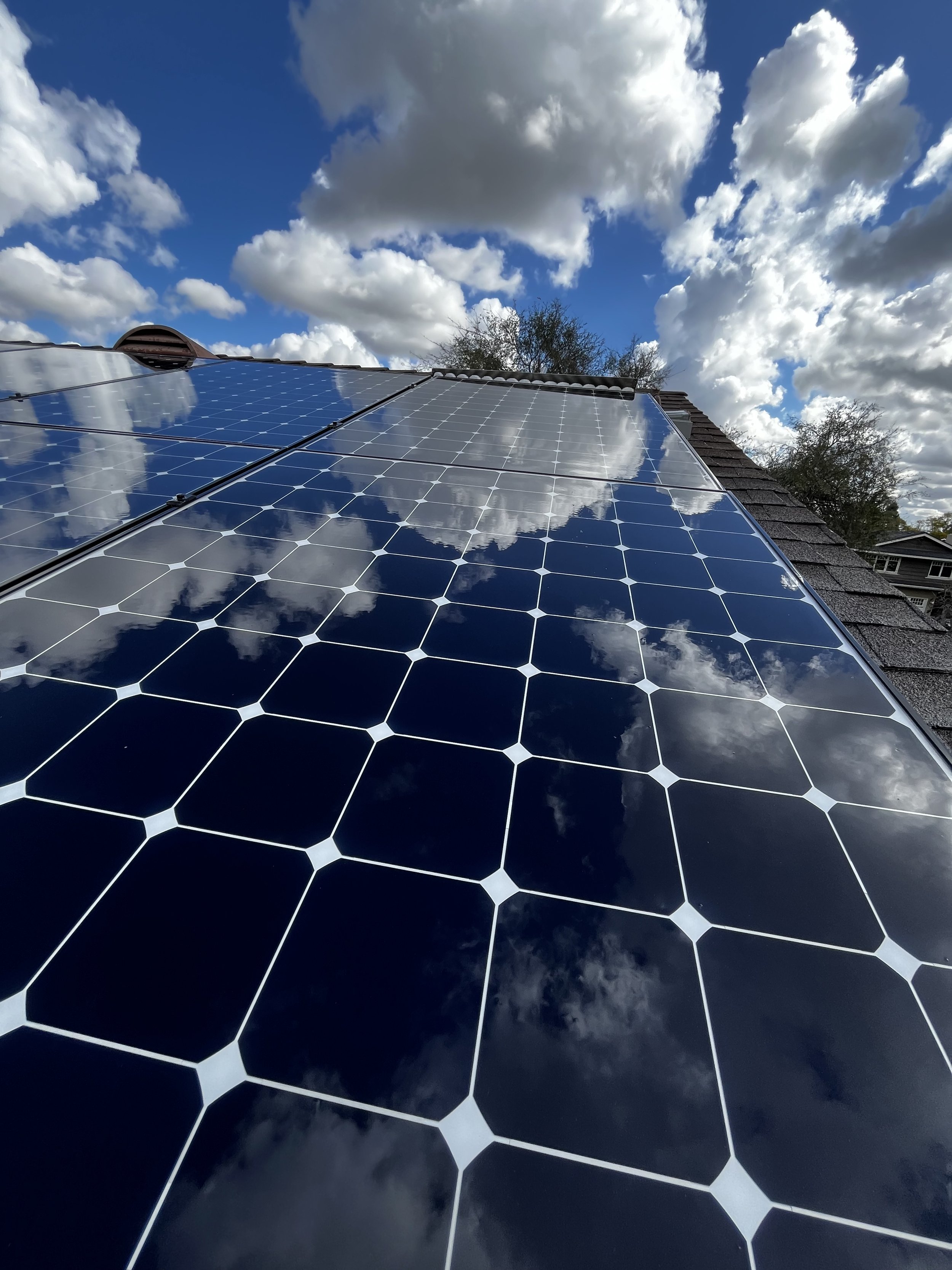 Clean residential solar panels in Long Beach, California, reflecting the blue sky after a thorough professional solar panel cleaning with purified deionized water. This chemical-free method safely removes dust, grime, and salt buildup, helping homeow