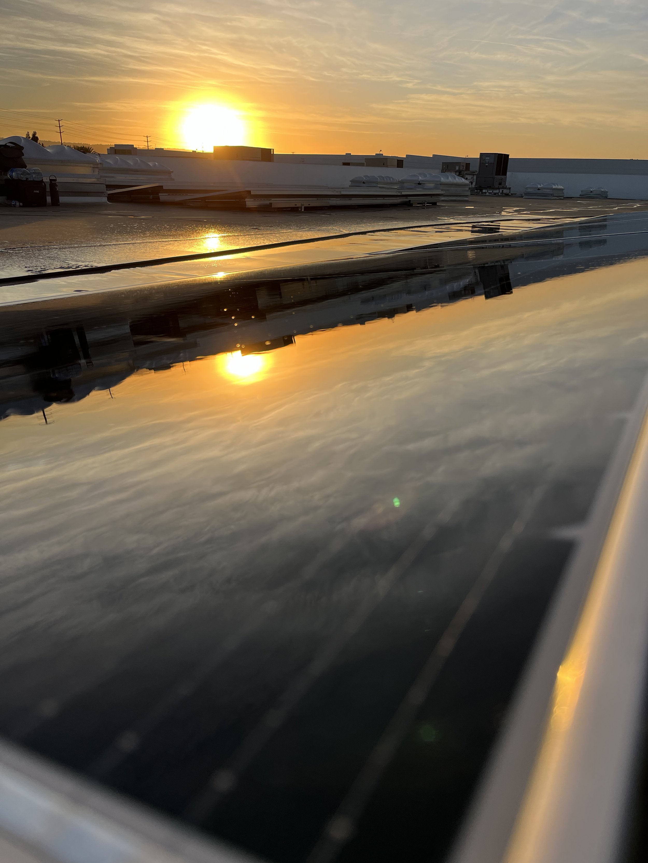 Freshly cleaned solar panels glowing under the Carson, California sunset after a full commercial rooftop cleaning service by Guru Solar Cleaning. This project highlights the efficiency, shine, and performance boost achieved through regular profession