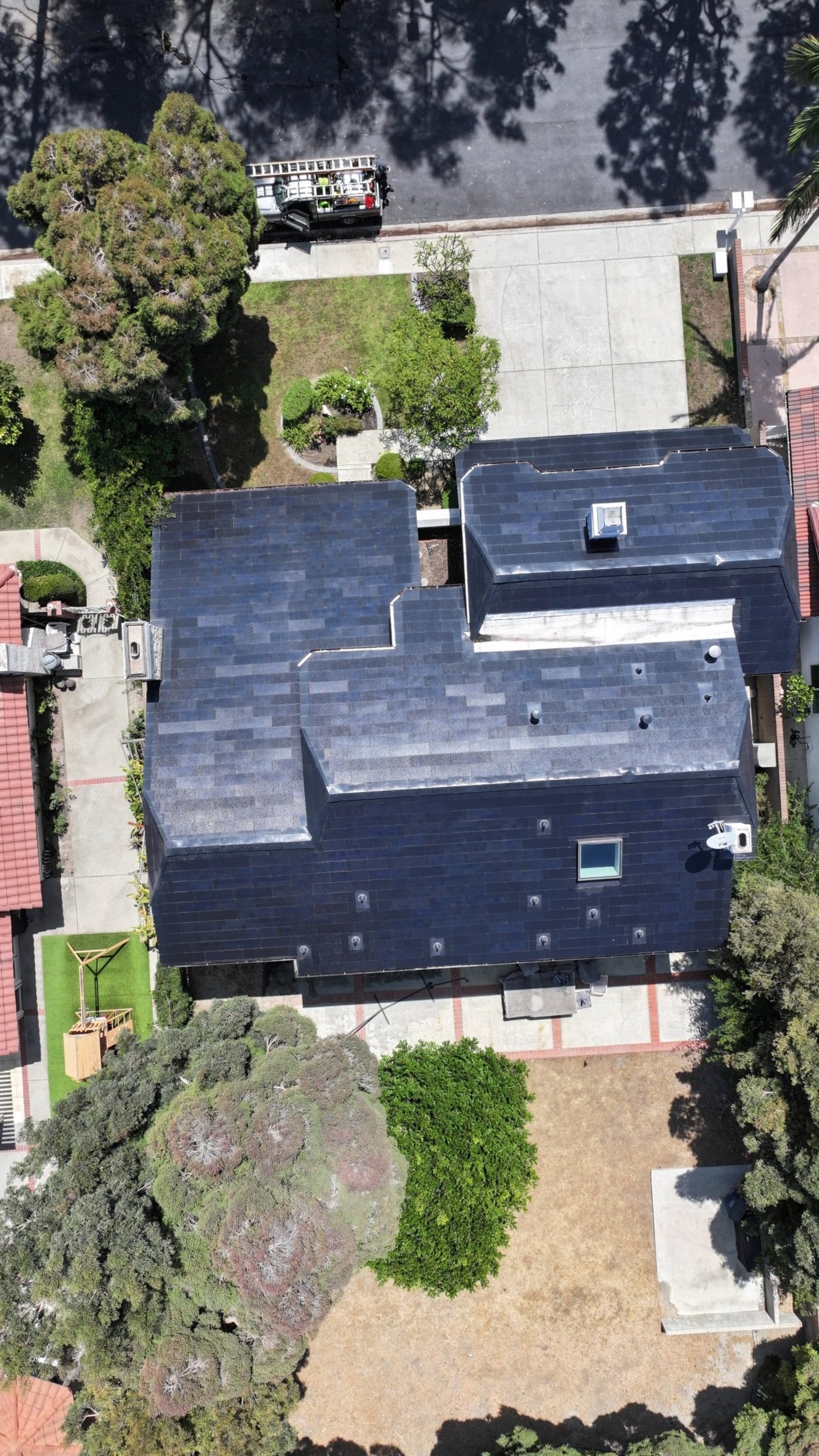 Another view of a clean Tesla solar roof following a detailed maintenance service in Long Beach, California. Using non-abrasive rotary brushes and deionized water, our crew safely removed grime and coastal buildup without risking damage to the solar