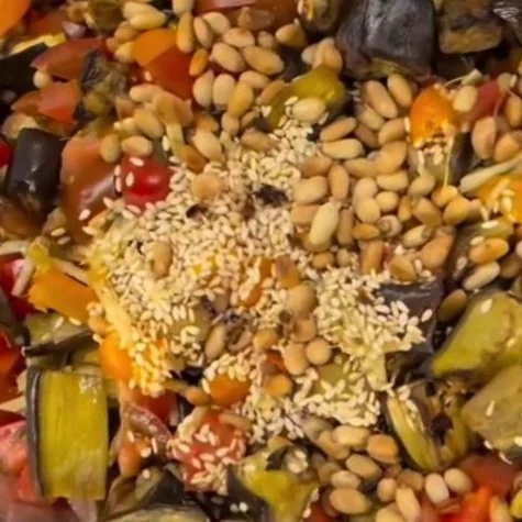 Close-up of a mixture of various seeds, nuts, and small dried vegetables.