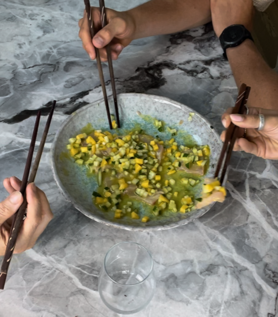 Kingi crudo eating with chopsticks