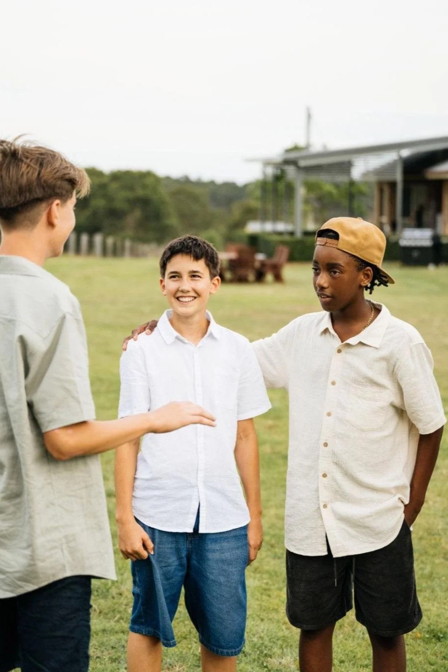 Group of teenage boys talking and spending time together outdoors.