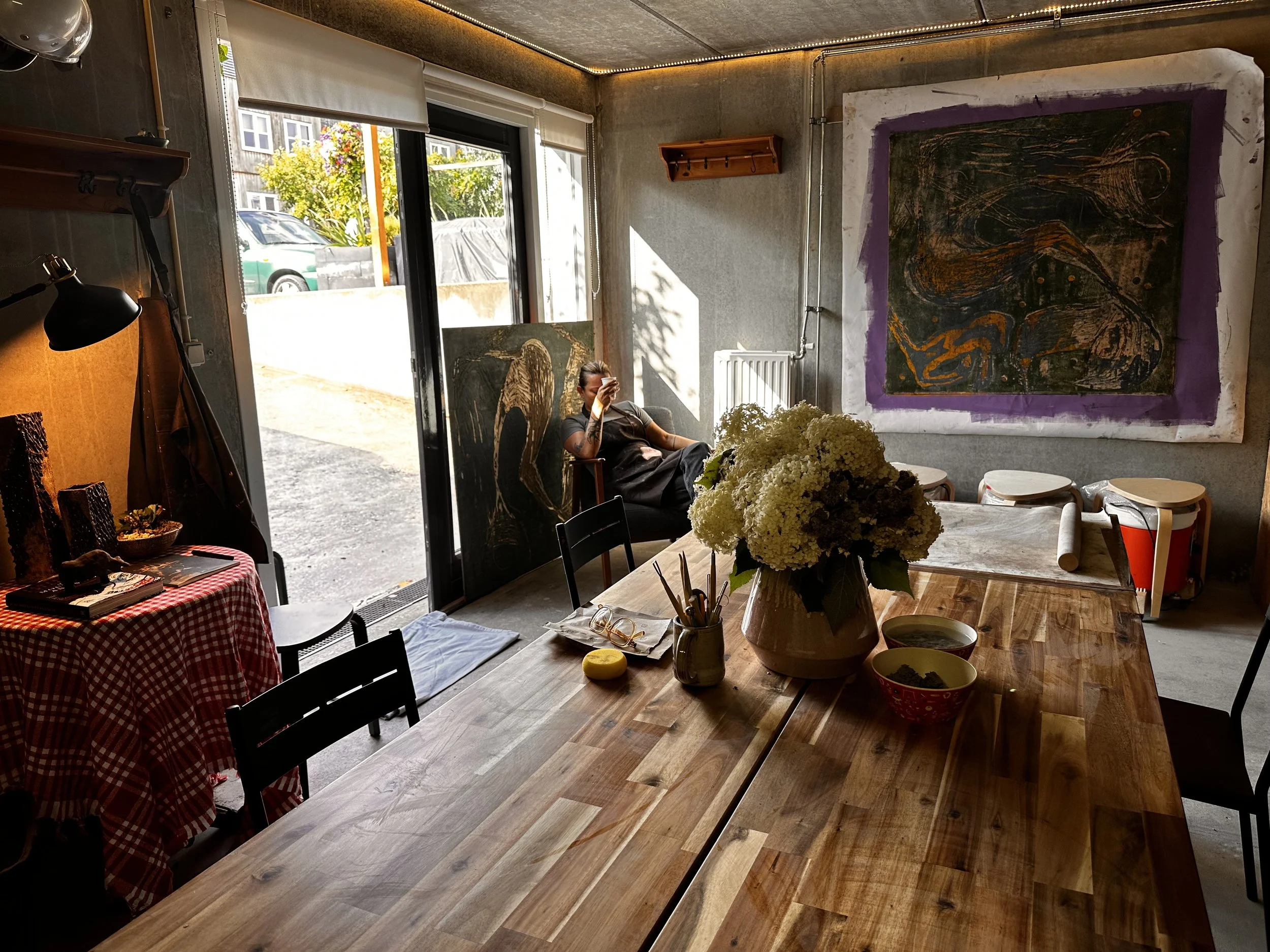 Ece Abay relaxing in her ceramic studio with a fresh cup of coffee