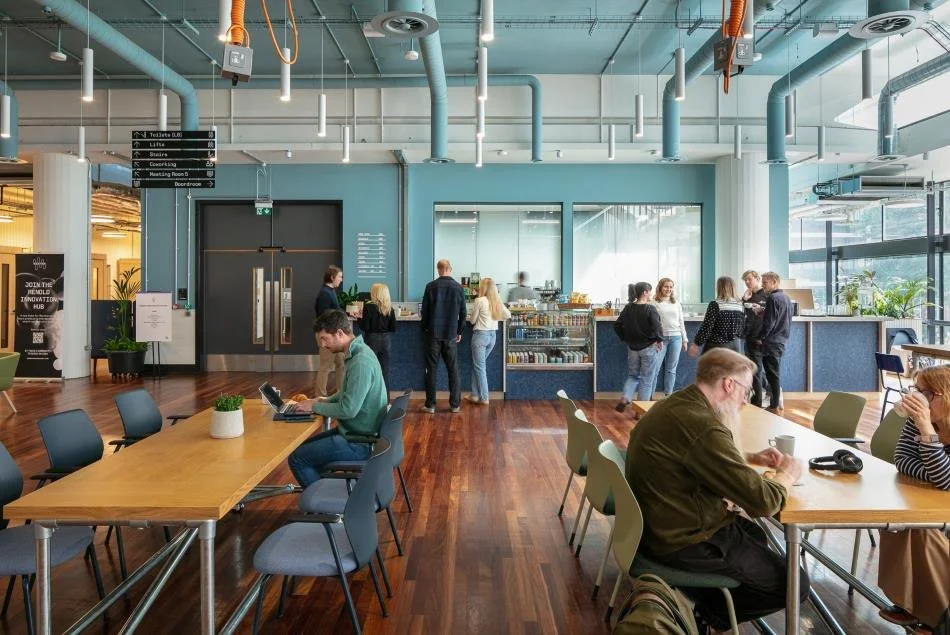 People working and meeting in the community café at The Renold Building in Manchester