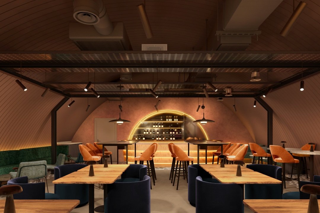 An elevated lounge and bar zone framed by an arched structure, with layered lighting, rich upholstery and curved detailing to create an intimate, welcoming guest experience.