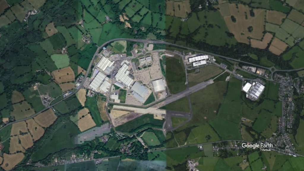 Aerial satellite view of the Samlesbury Enterprise Zone showing industrial buildings, roads and surrounding green fields in Lancashire.